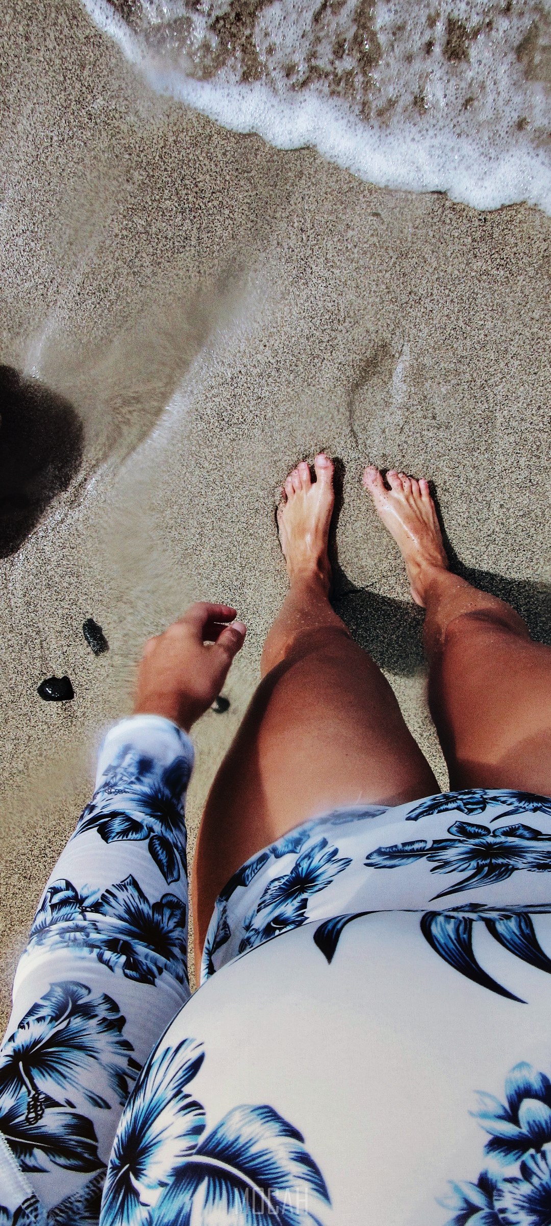 Person's legs and feet on a sandy beach with waves HD Phone Wallpaper
