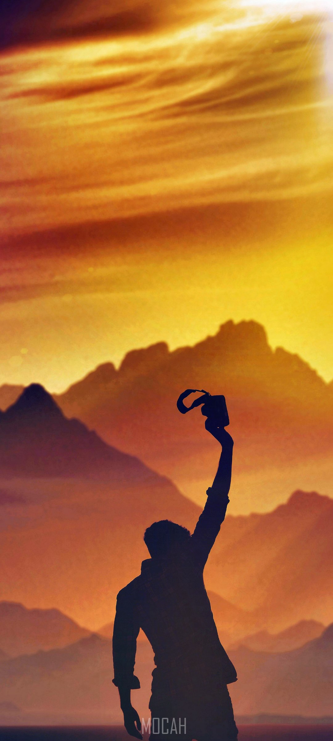 Silhouette of a person holding a camera against mountains and sunset HD Phone Wallpaper