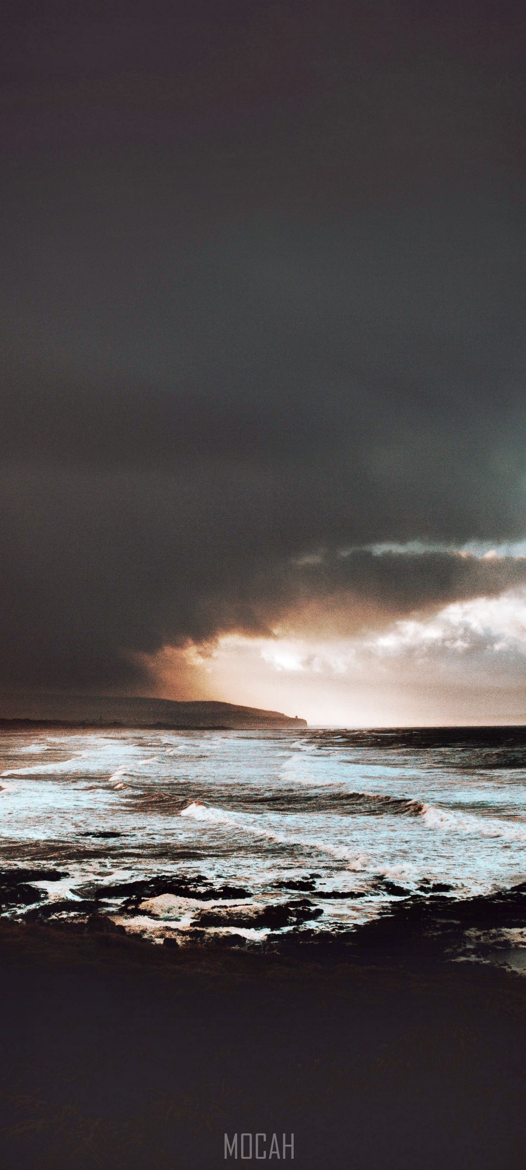 Stormy ocean waves crashing on shore with dramatic clouds HD Phone Wallpaper