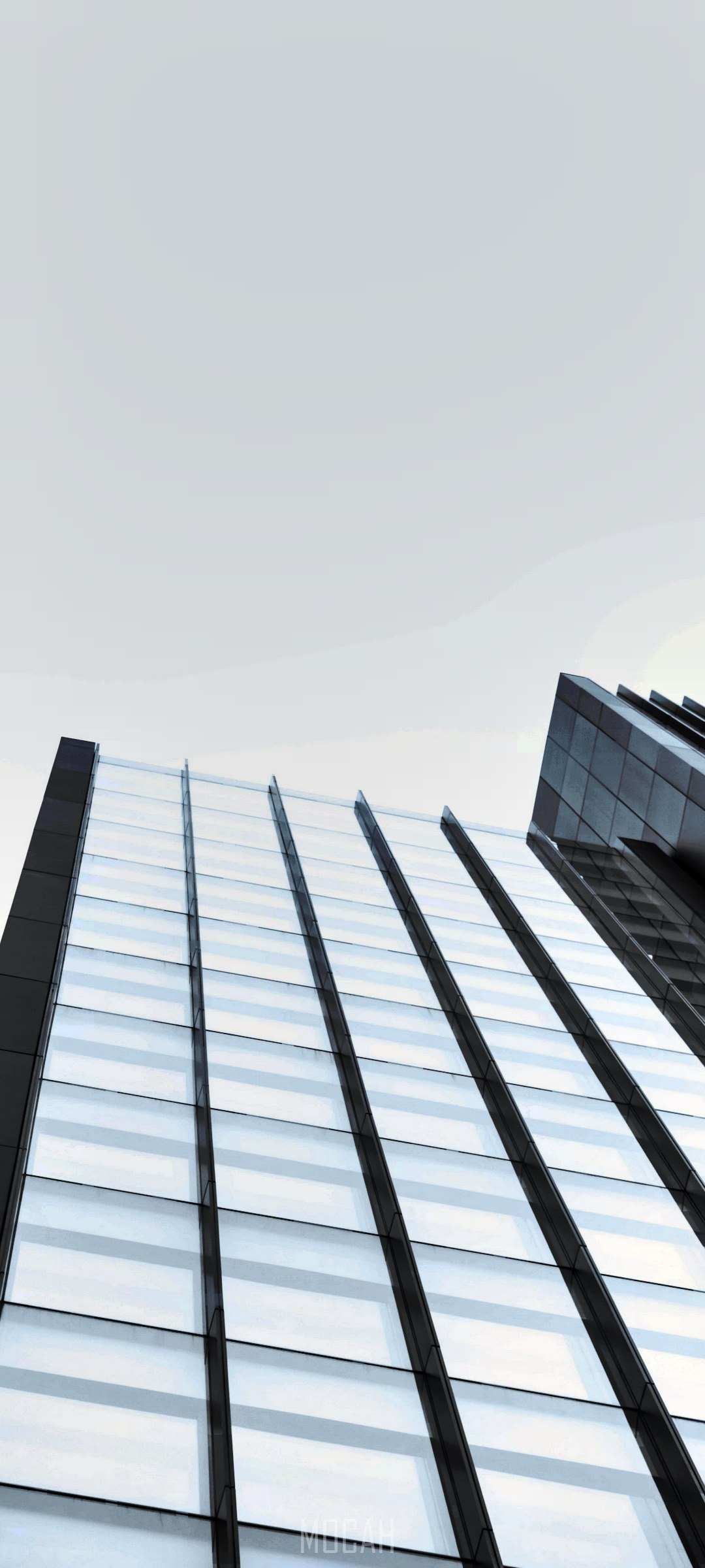 Modern glass skyscraper reflecting cloudy sky HD Phone Wallpaper