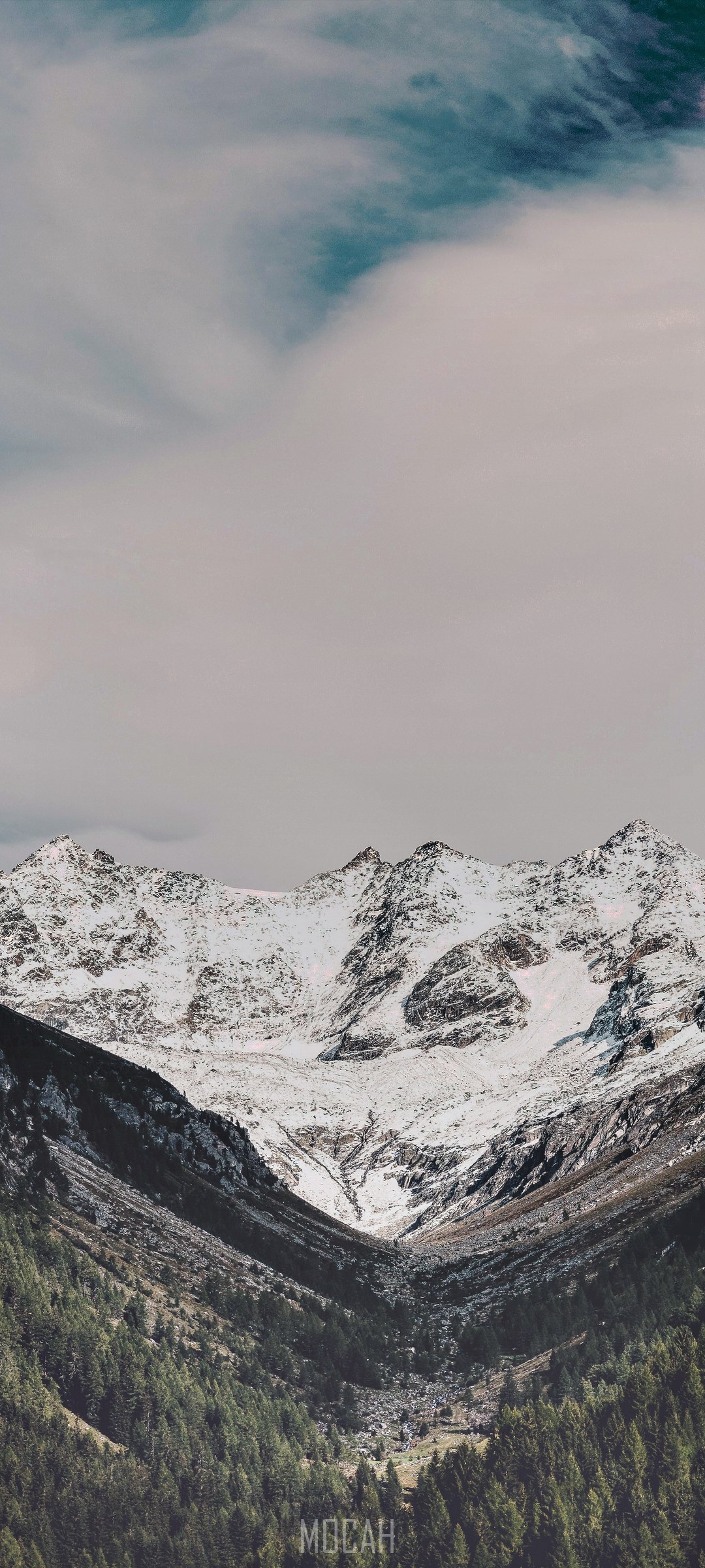 Snow-Covered Mountain Peaks under a Cloudy Sky HD Phone Wallpaper