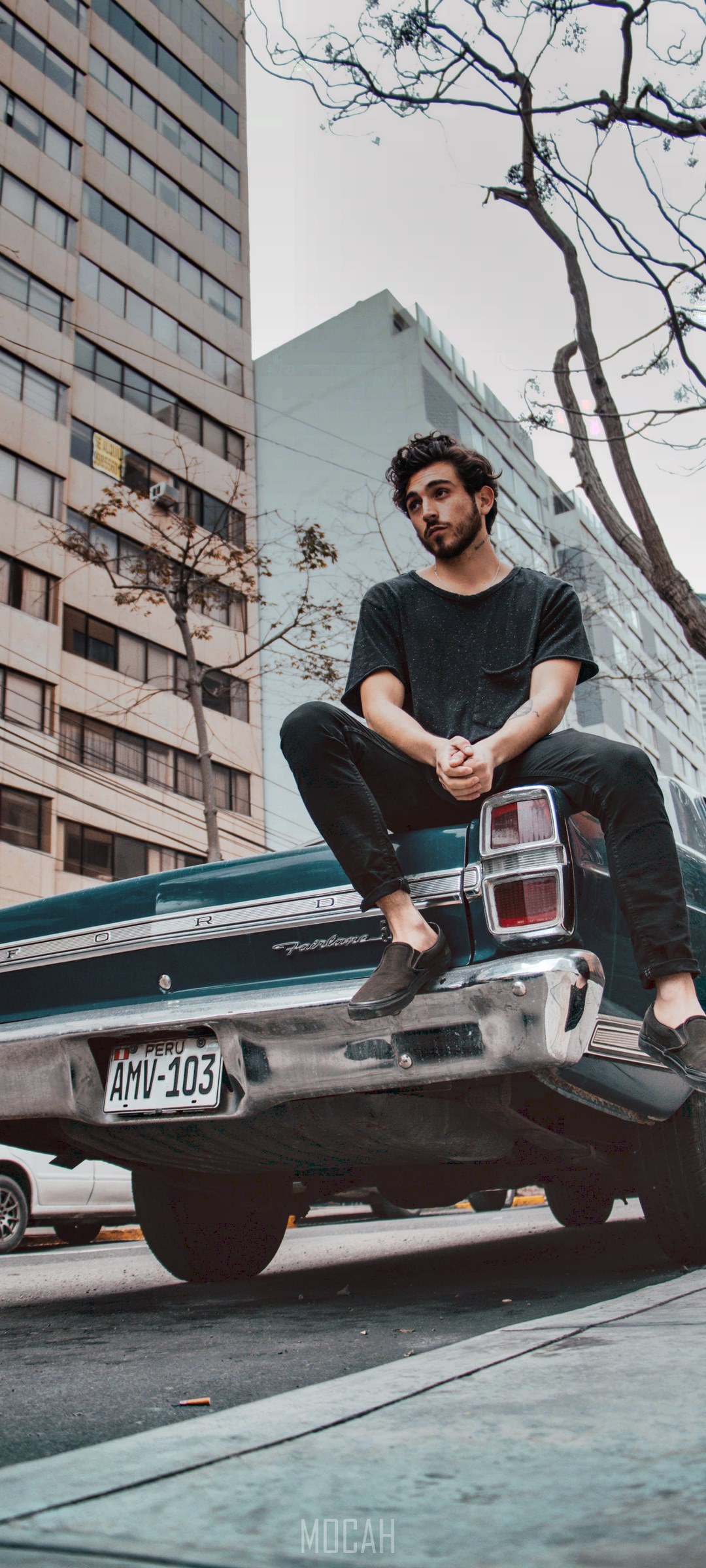 Man sitting on the trunk of a classic car HD Phone Wallpaper
