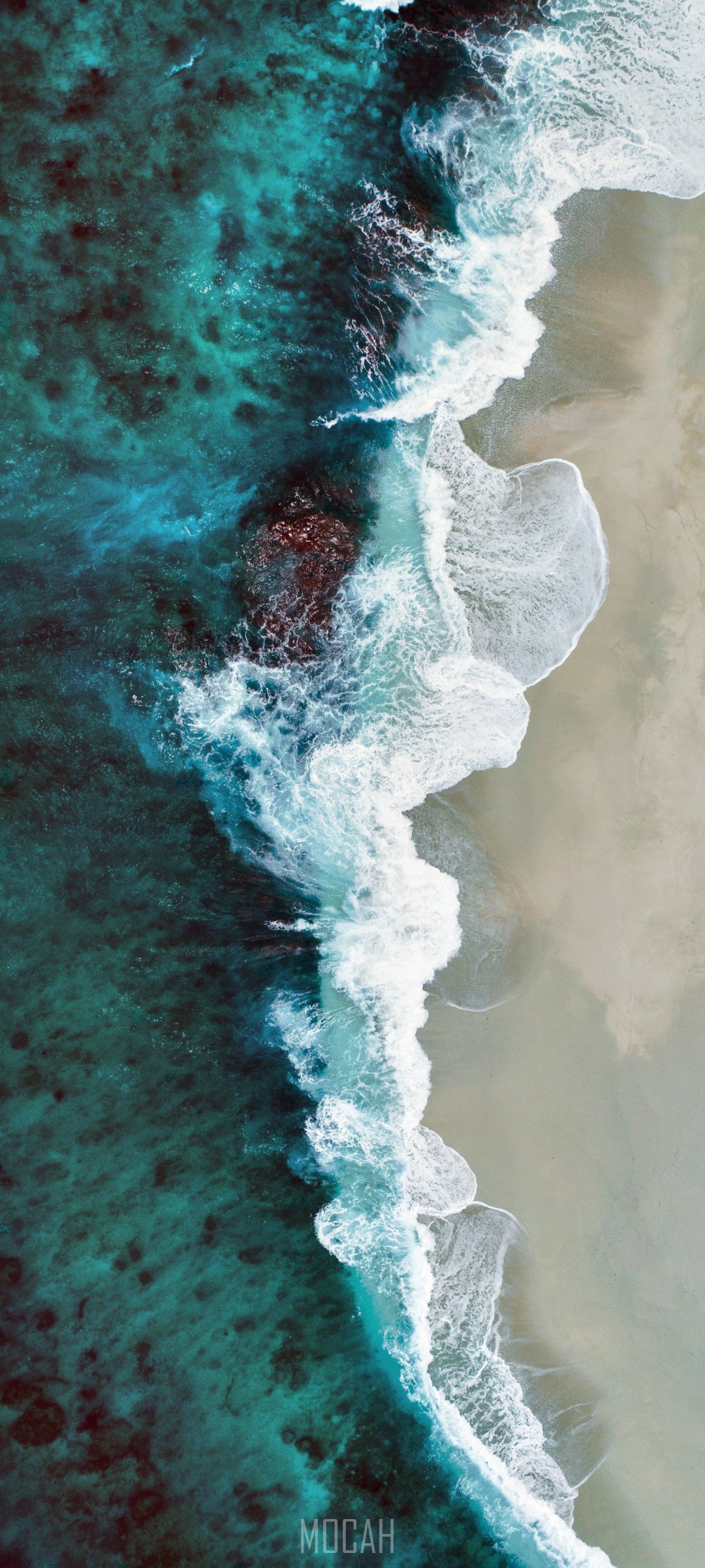 Aerial view of ocean waves crashing on a sandy beach HD Phone Wallpaper