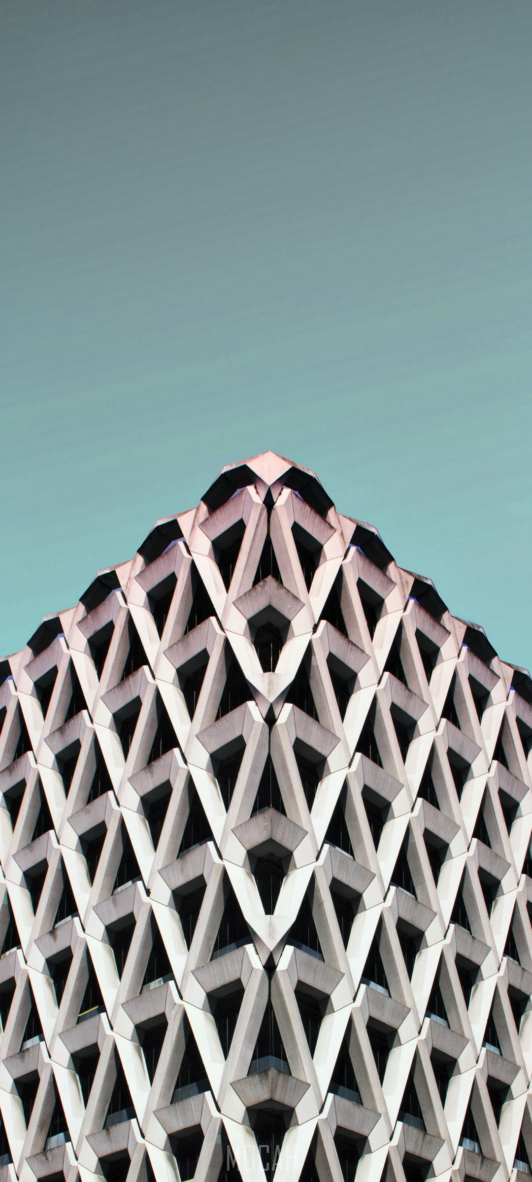 Geometric building facade against a teal sky HD Phone Wallpaper