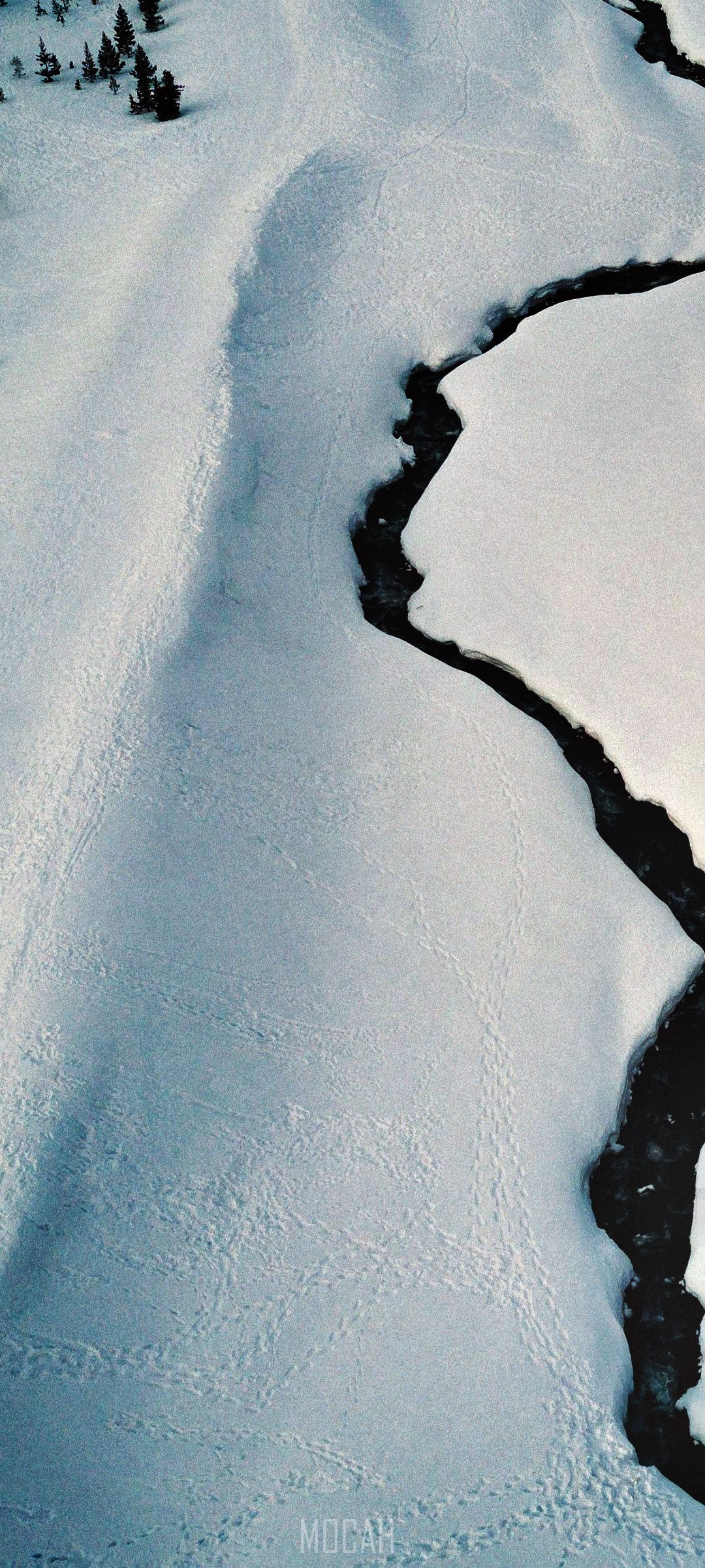 Drone shot of a river flowing through snowy plains HD Phone Wallpaper