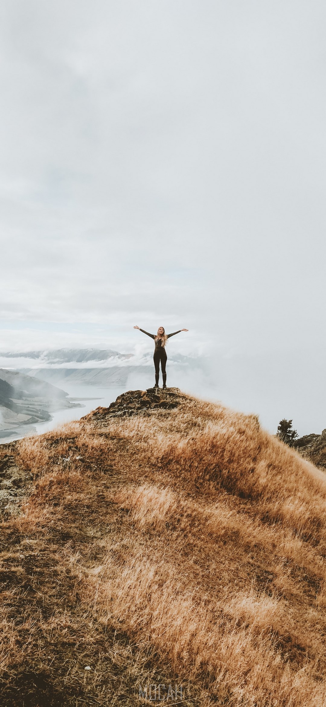 #271057 a woman standing on a cliff with her arms spread open ...