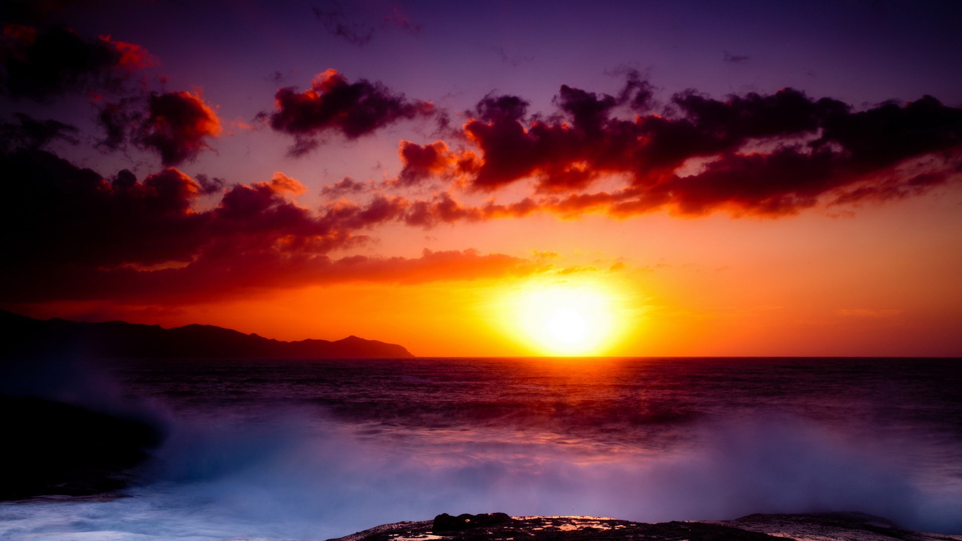 Sunset over the ocean with dramatic clouds and waves HD Wallpaper