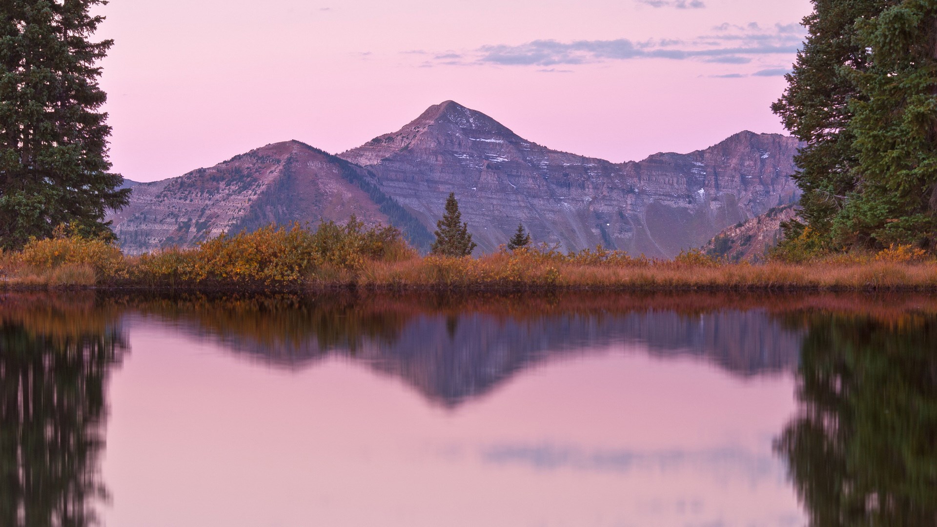 Mountain reflected in a calm lake at sunset HD Wallpaper