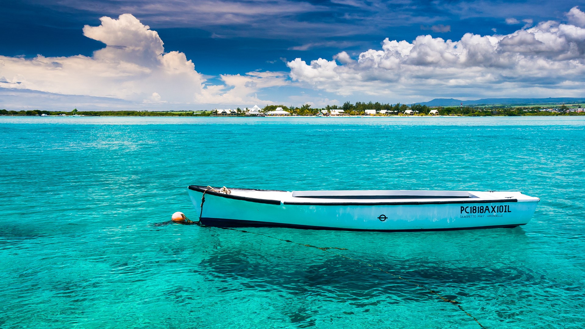 Boat on turquoise water with distant island HD Wallpaper