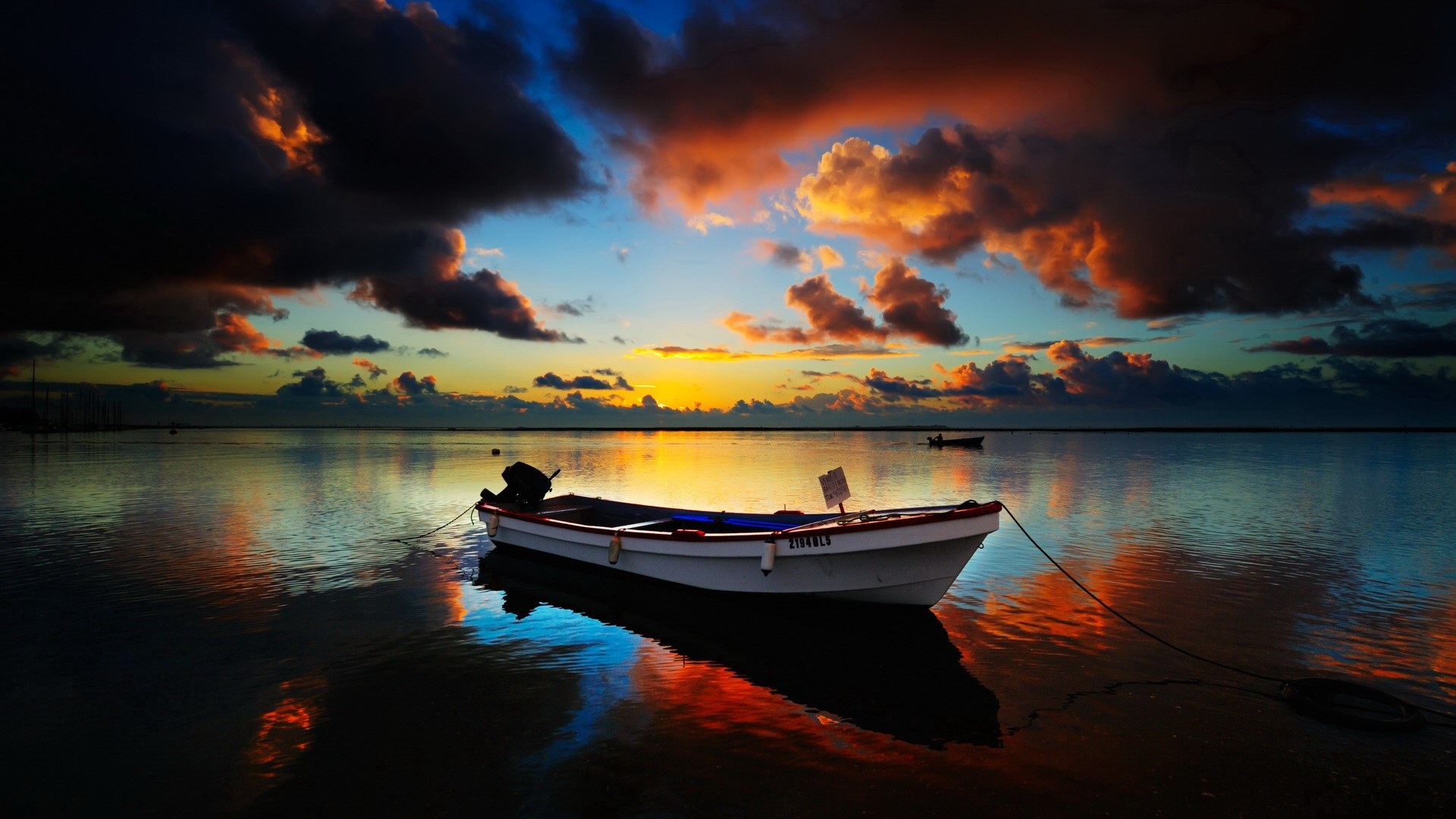 Boat on calm water during sunset with colorful clouds HD Wallpaper