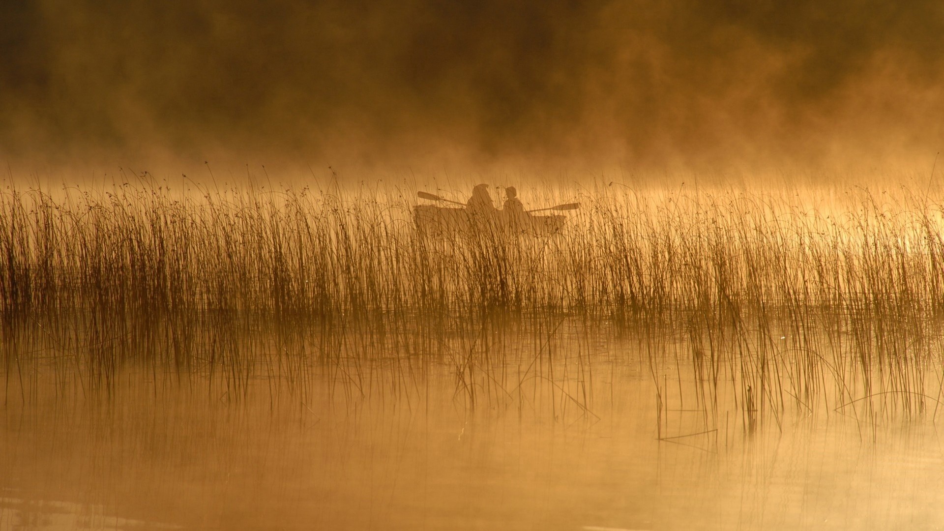 Two people in a boat on a misty lake HD Wallpaper