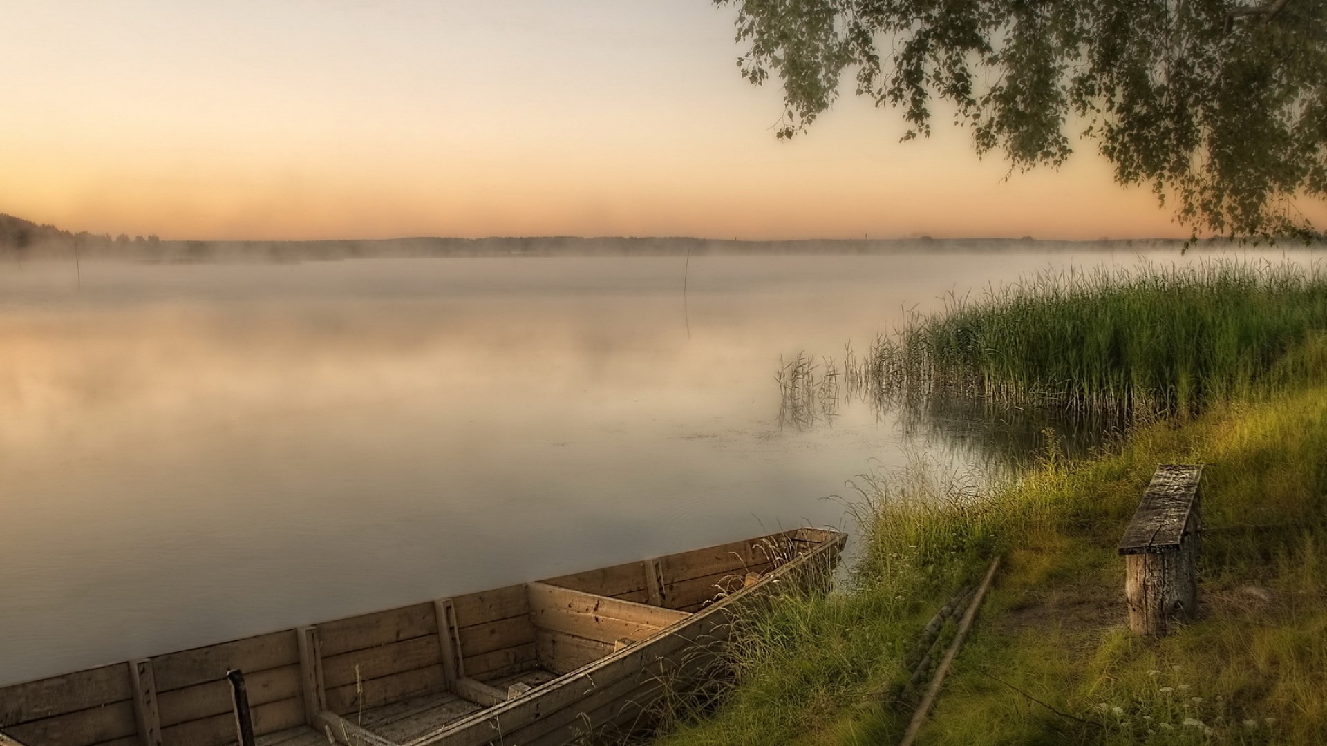 Wooden boat on a misty lake at sunrise HD Wallpaper