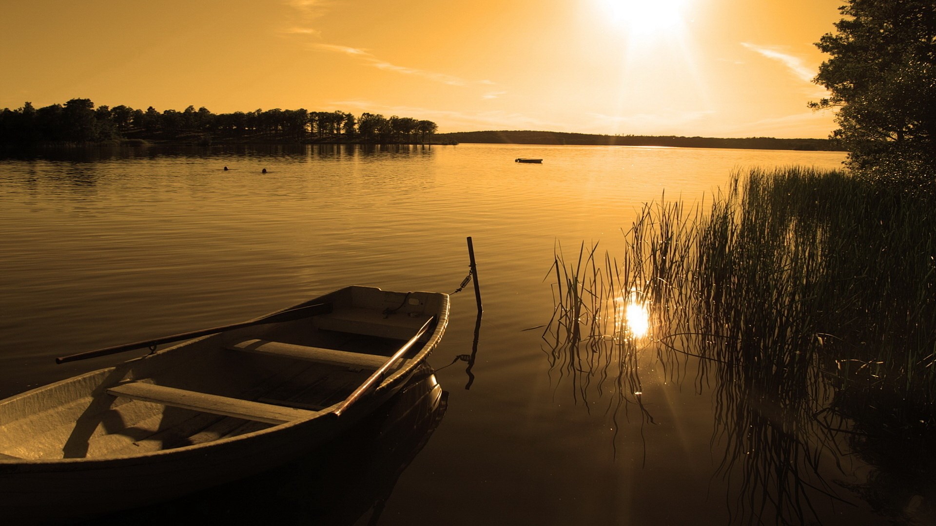 Boat on a lake at sunset HD Wallpaper