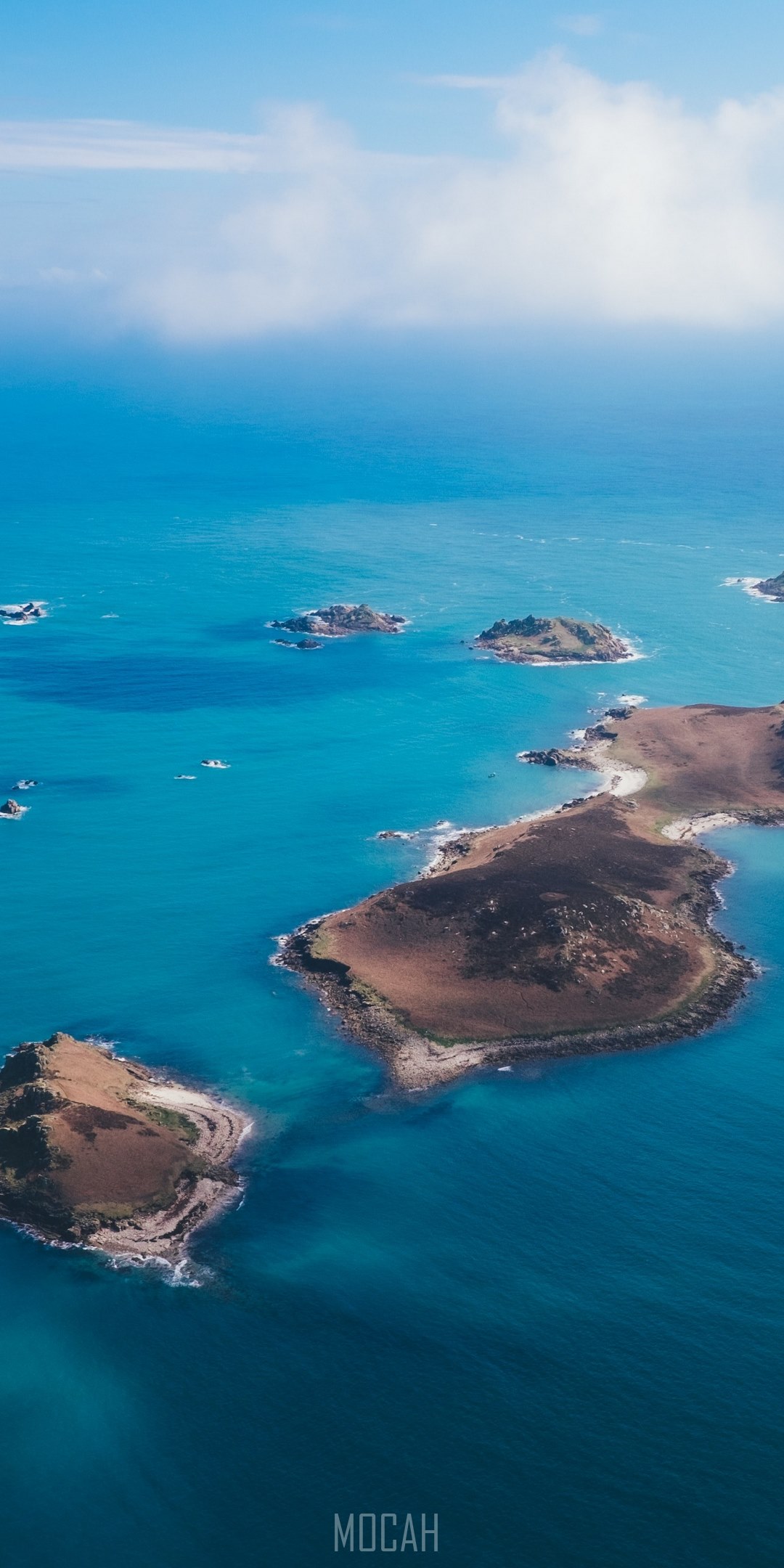 Scilly Isles Computer Background drone view of the isles of scilly poking out of clear blue water on a ...