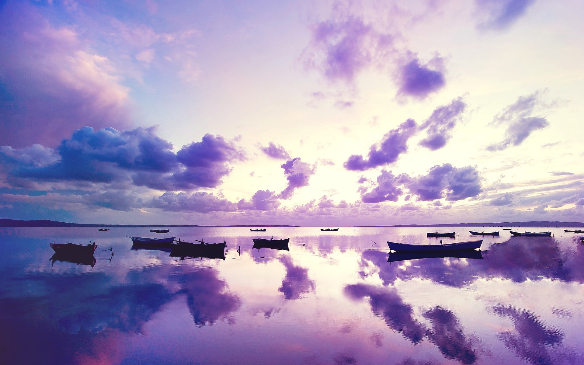 Boats on a calm lake at sunset with purple clouds HD Wallpaper