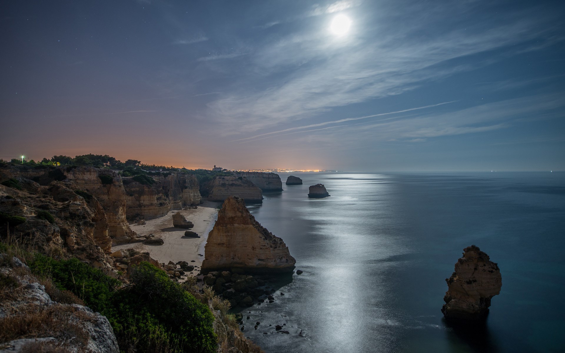 Moonlit coast with rock formations and ocean HD Wallpaper