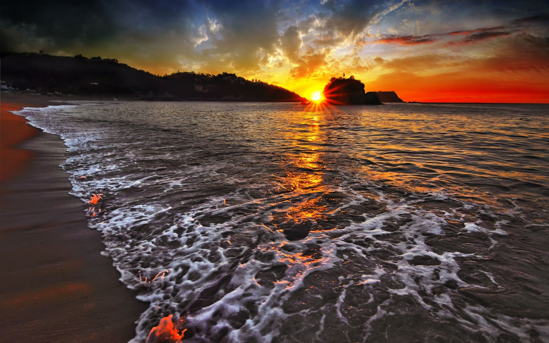 Sunset over a beach with waves crashing HD Wallpaper