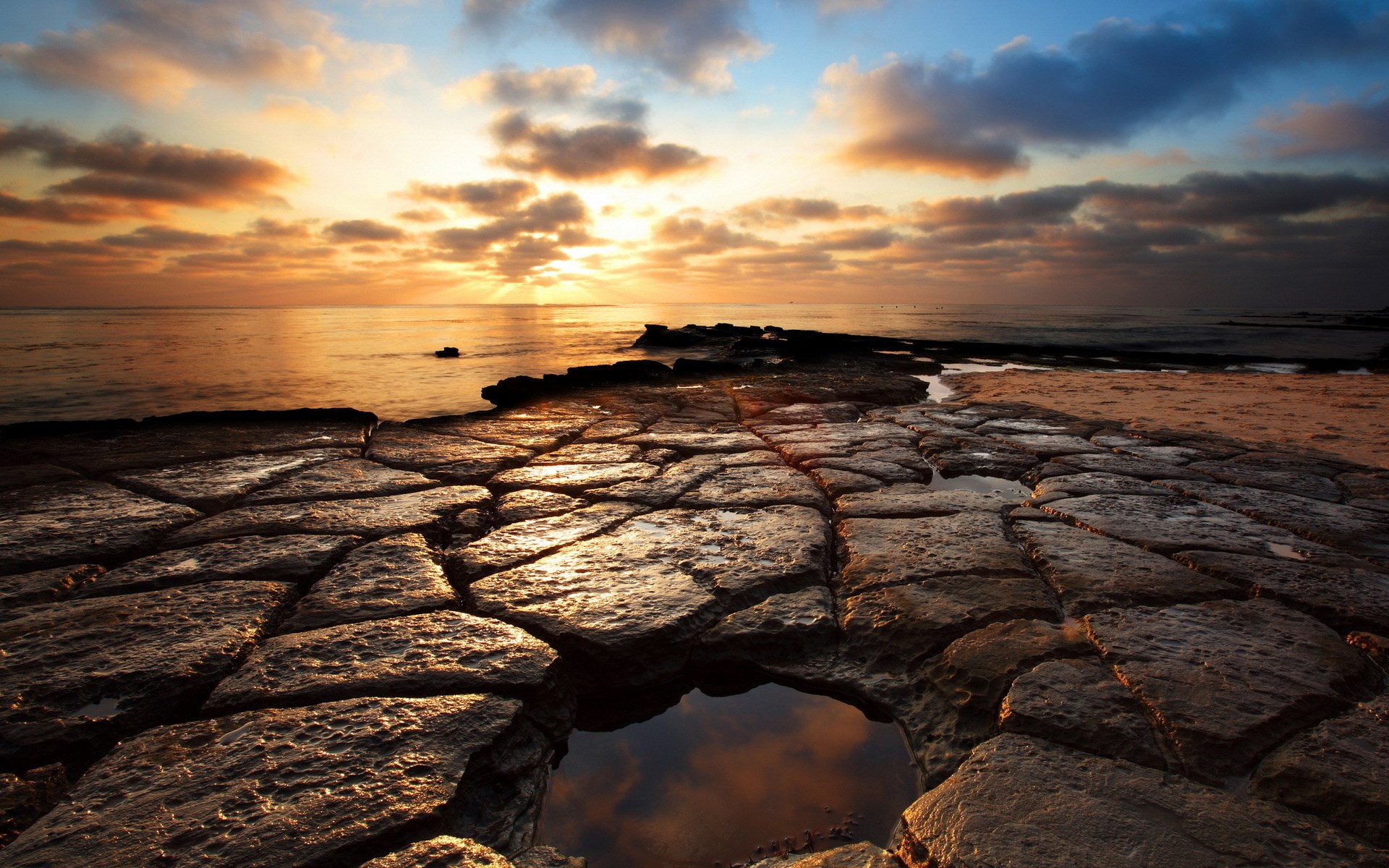 Sunset over rocky coastline with tide pools HD Wallpaper