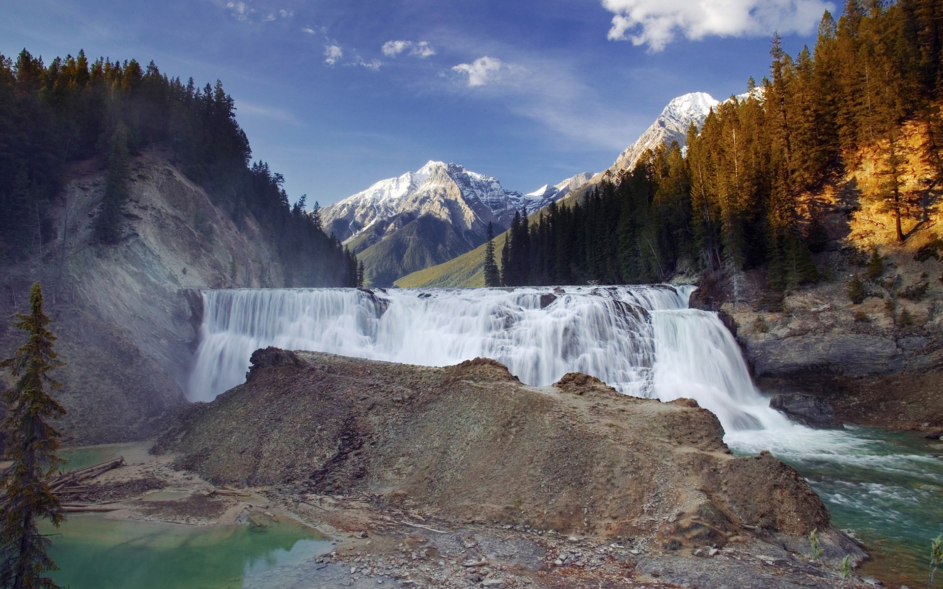 Waterfall in a mountain landscape with pine trees HD Wallpaper