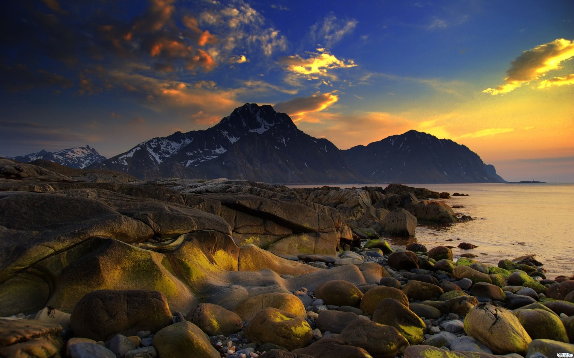 Rocky coastline with mountains at sunset HD Wallpaper