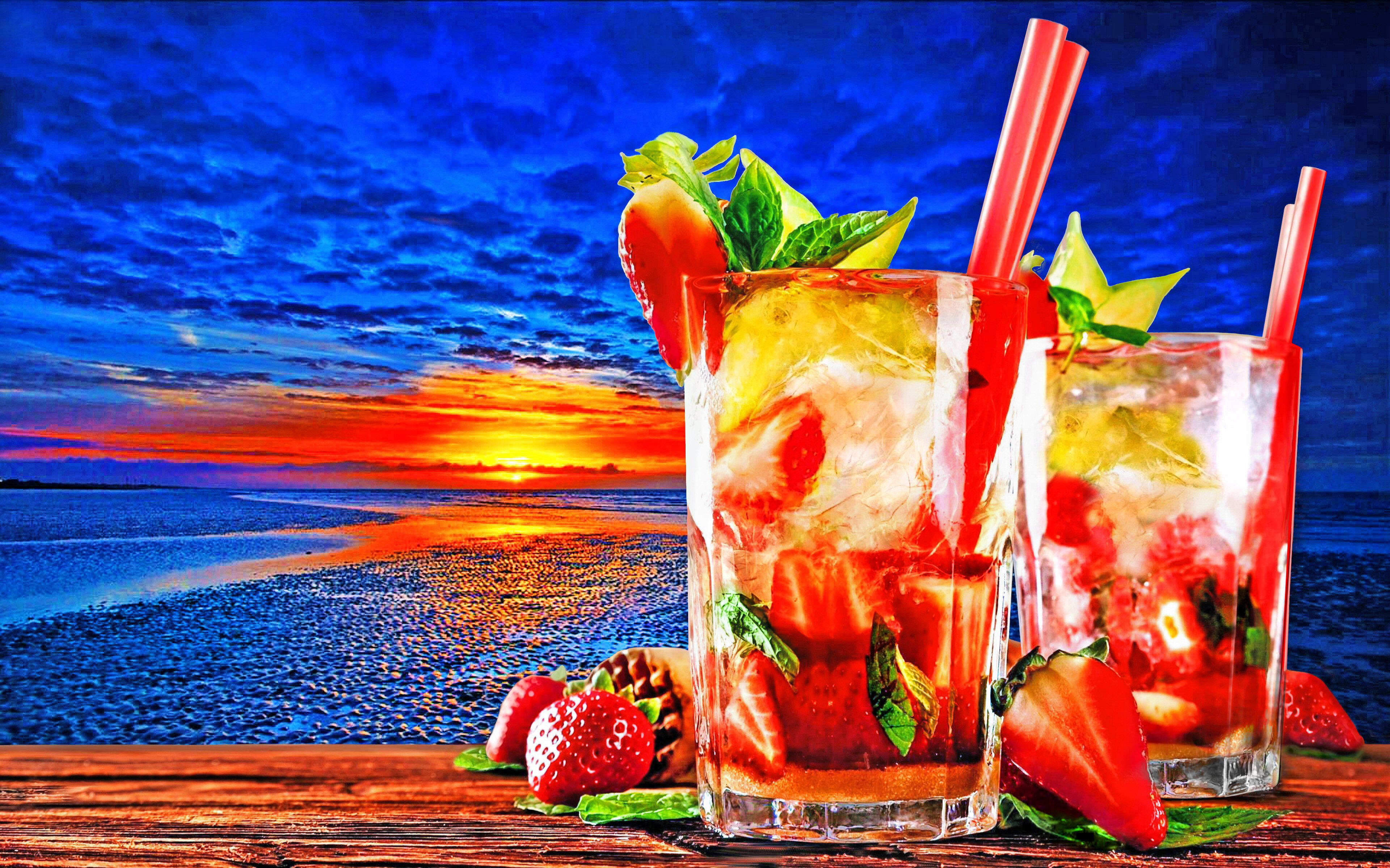 Two tropical cocktails on a wooden table at sunset HD Wallpaper