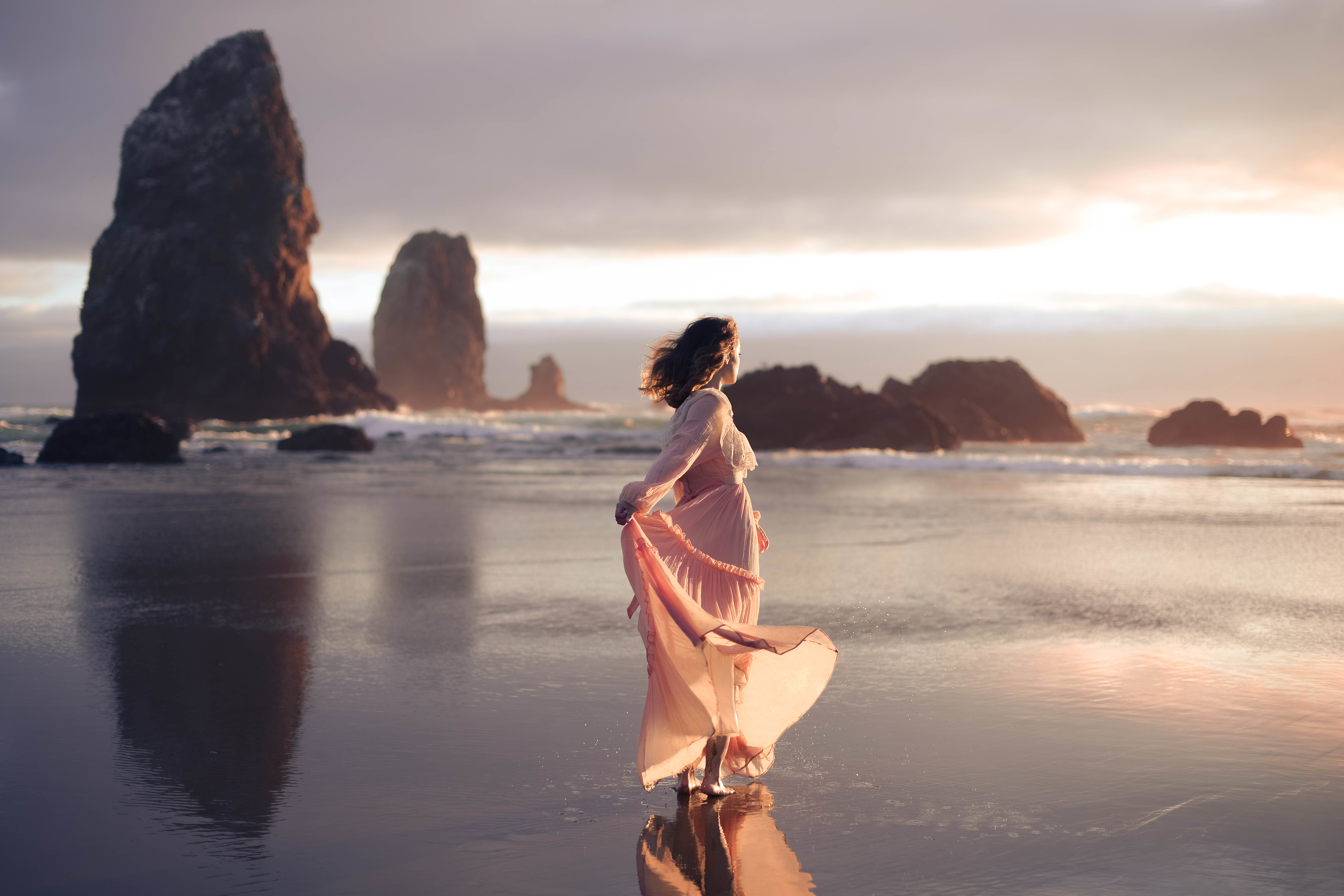 Woman in a flowing dress on a beach at sunset HD Wallpaper