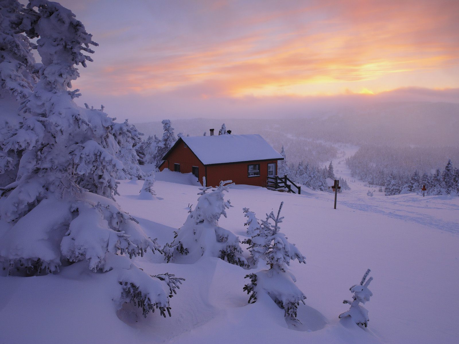 Cabin in snowy landscape at sunset HD Wallpaper