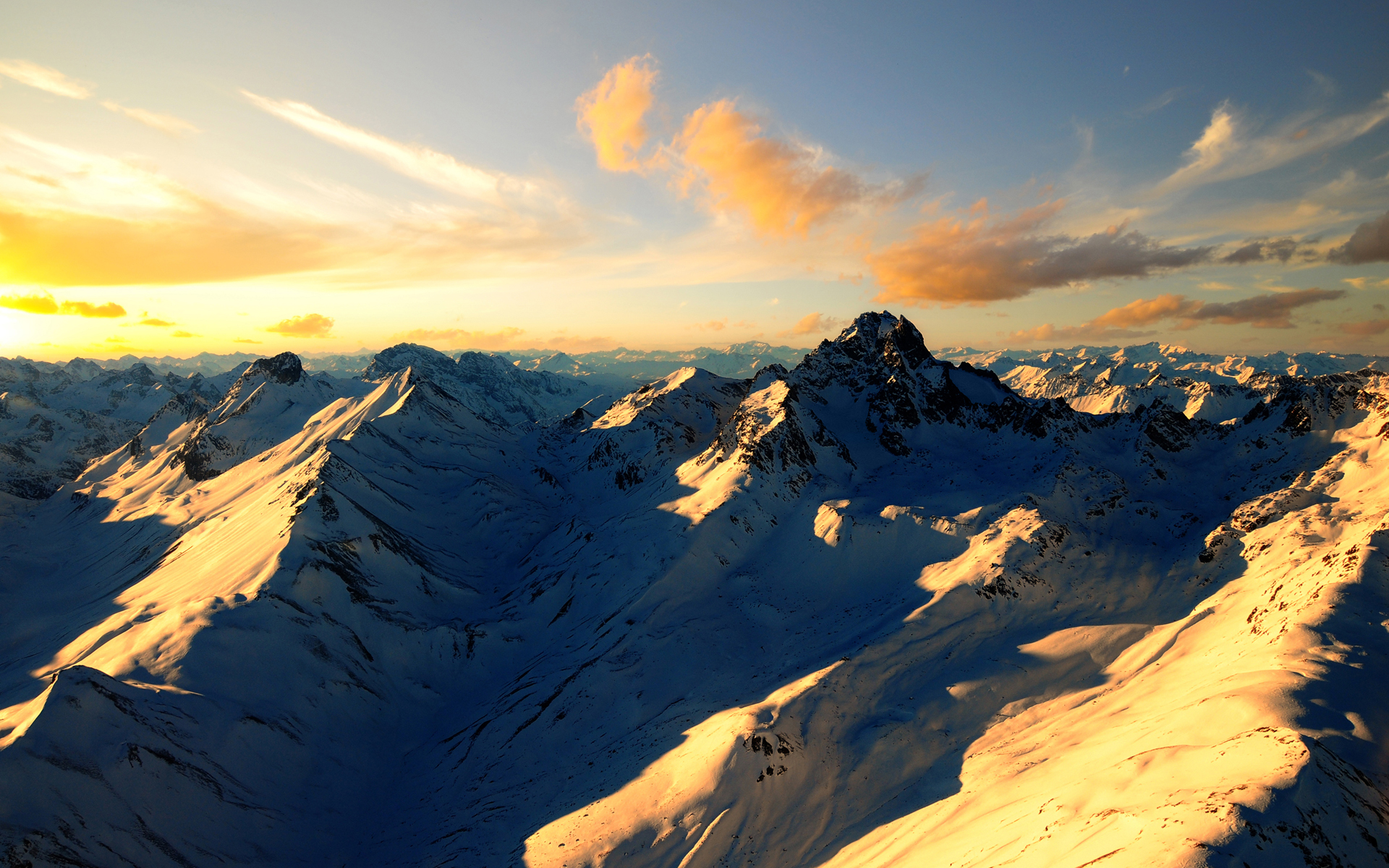 Snowy mountain range at sunset HD Wallpaper