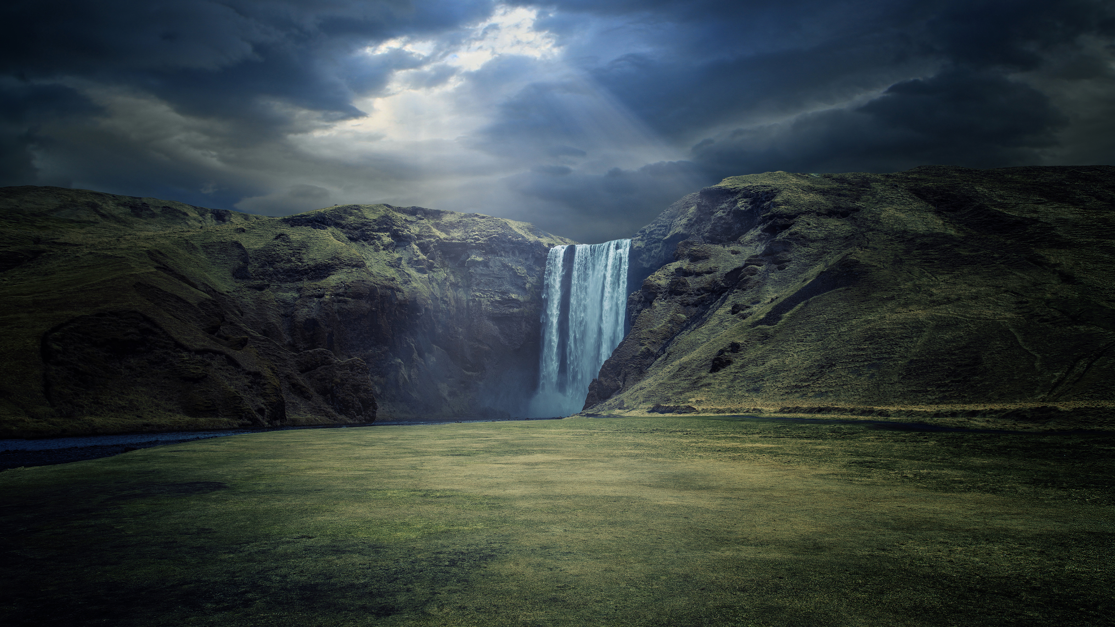 Skógafoss Waterfall under dramatic clouds HD Wallpaper