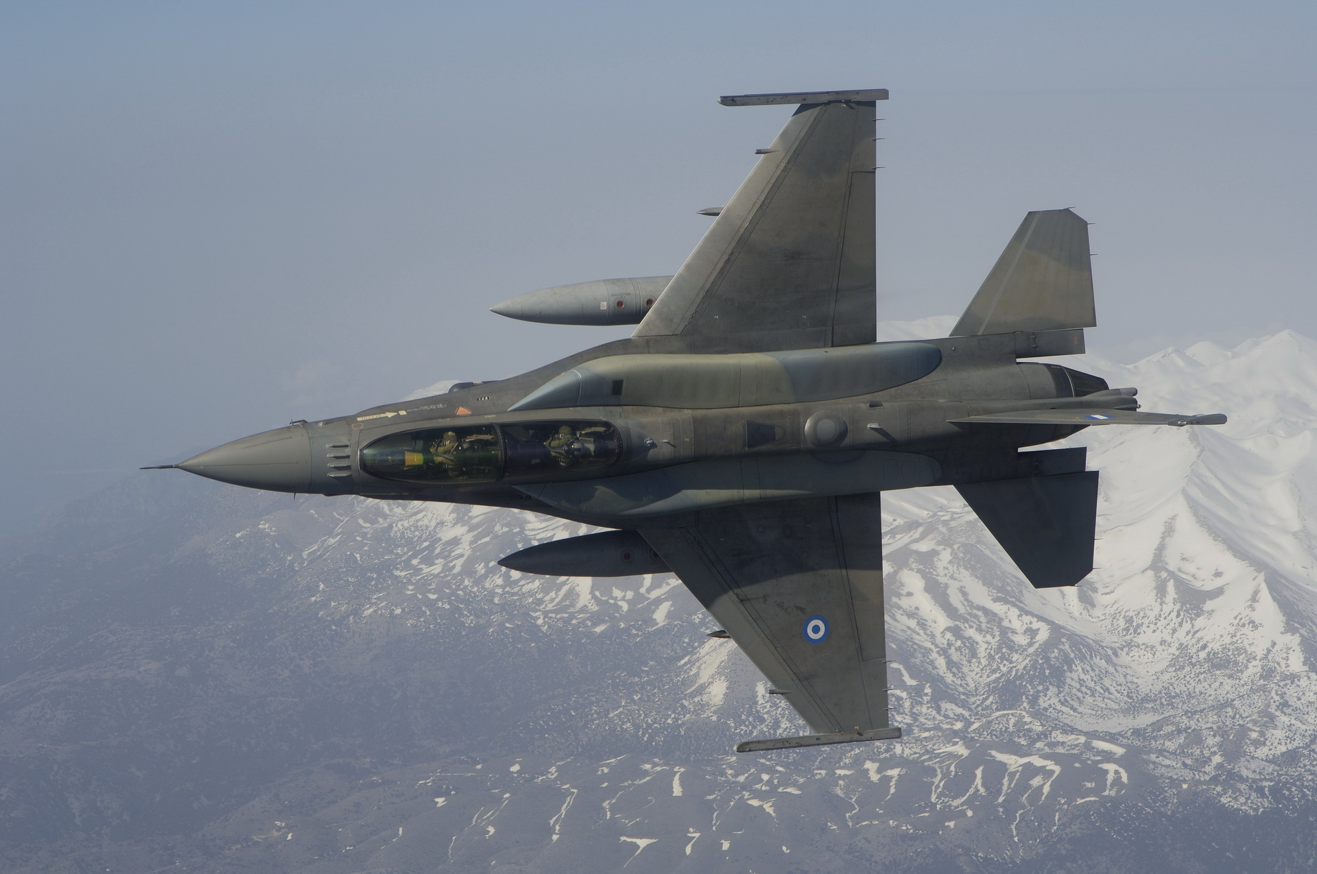 Greek F-16 Fighting Falcon flying over mountains HD Wallpaper