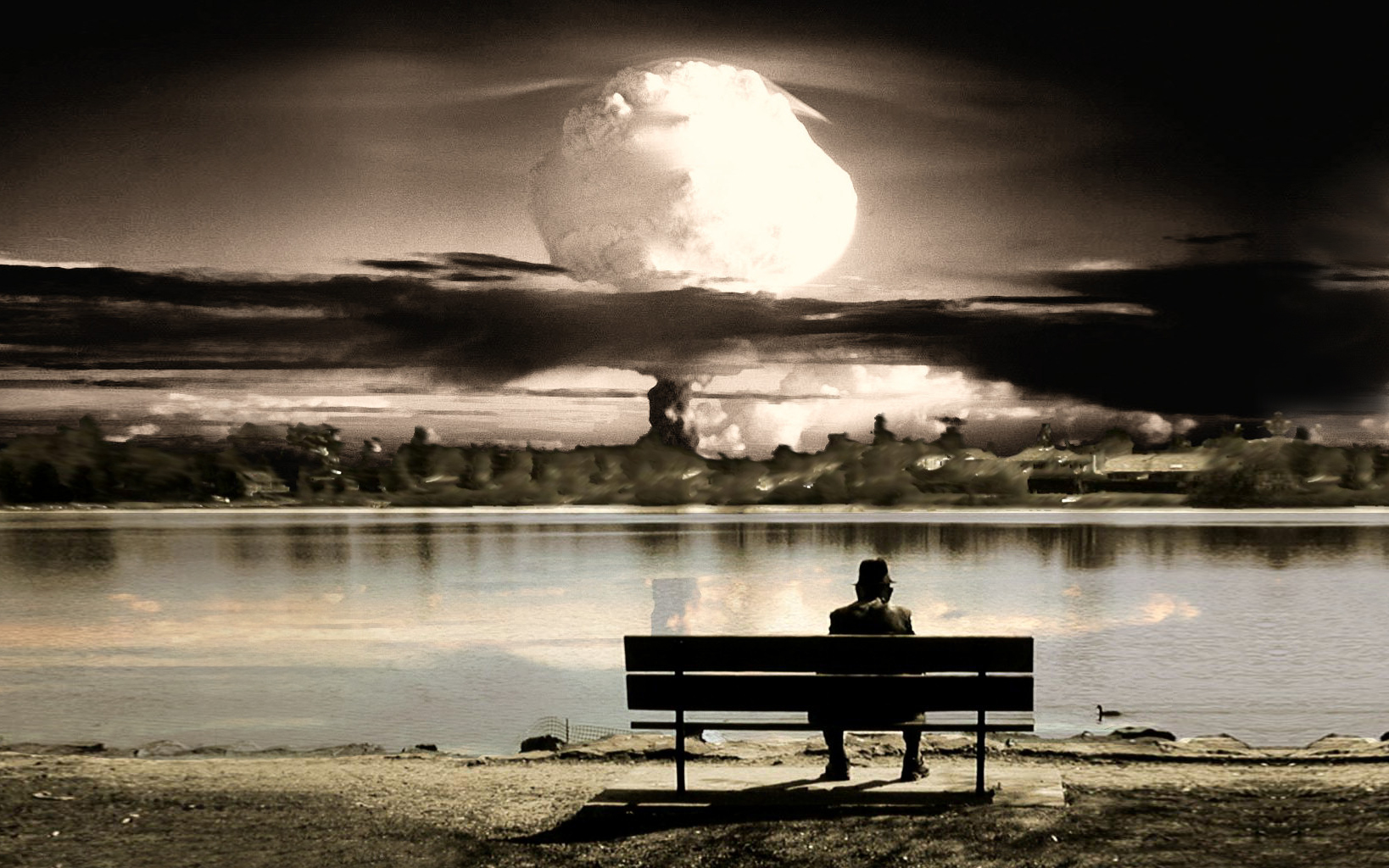 Man sits on bench watching nuclear explosion over lake HD Wallpaper