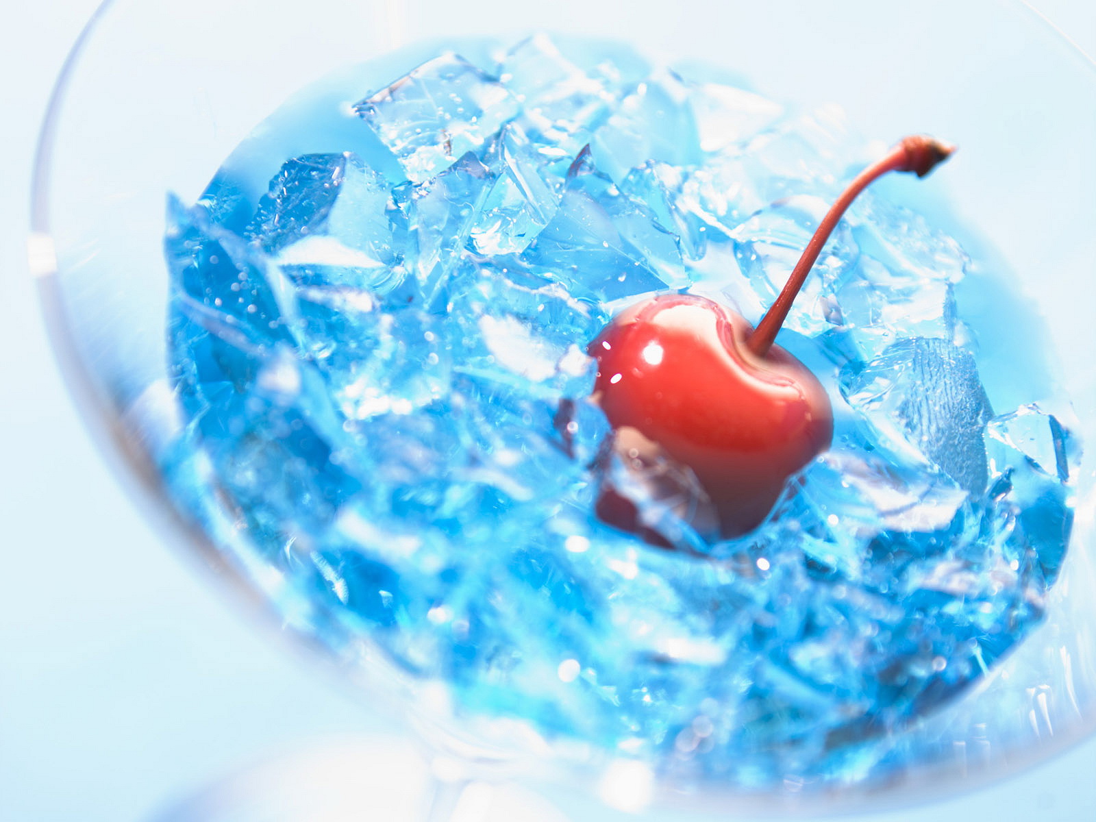 Cherry in blue ice cubes in a glass HD Wallpaper