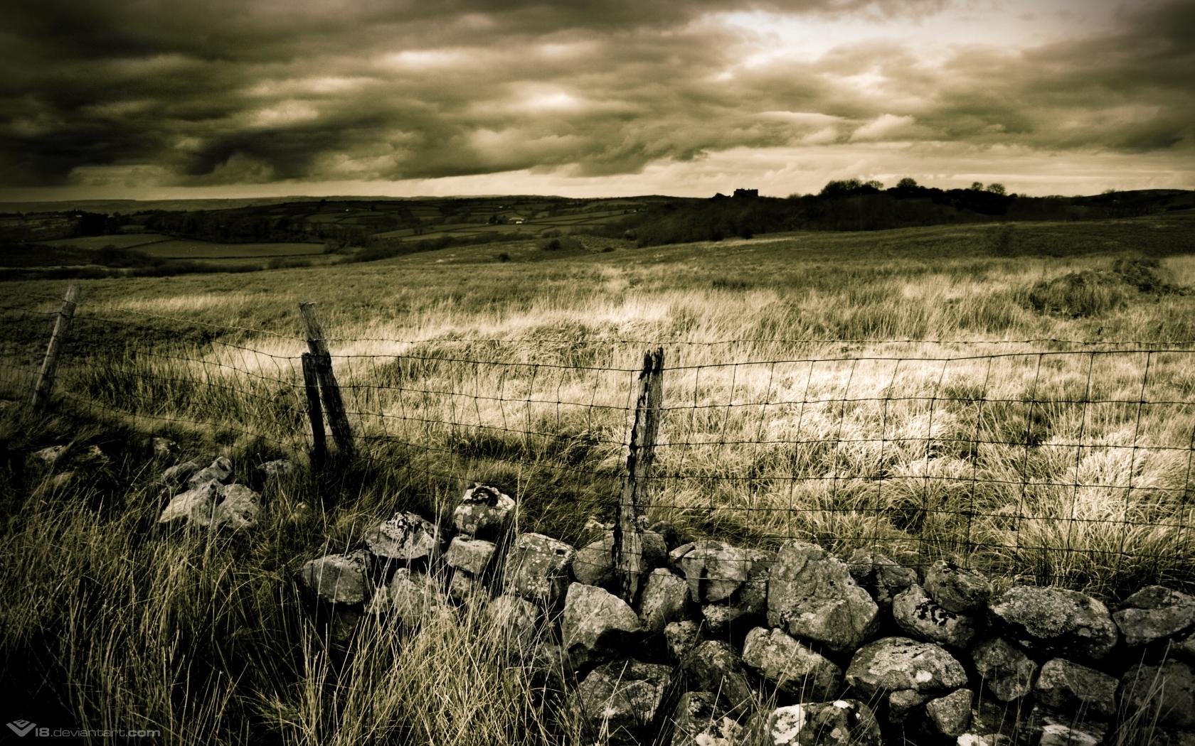 Overcast sky over a rural field with a stone wall and fence HD Wallpaper