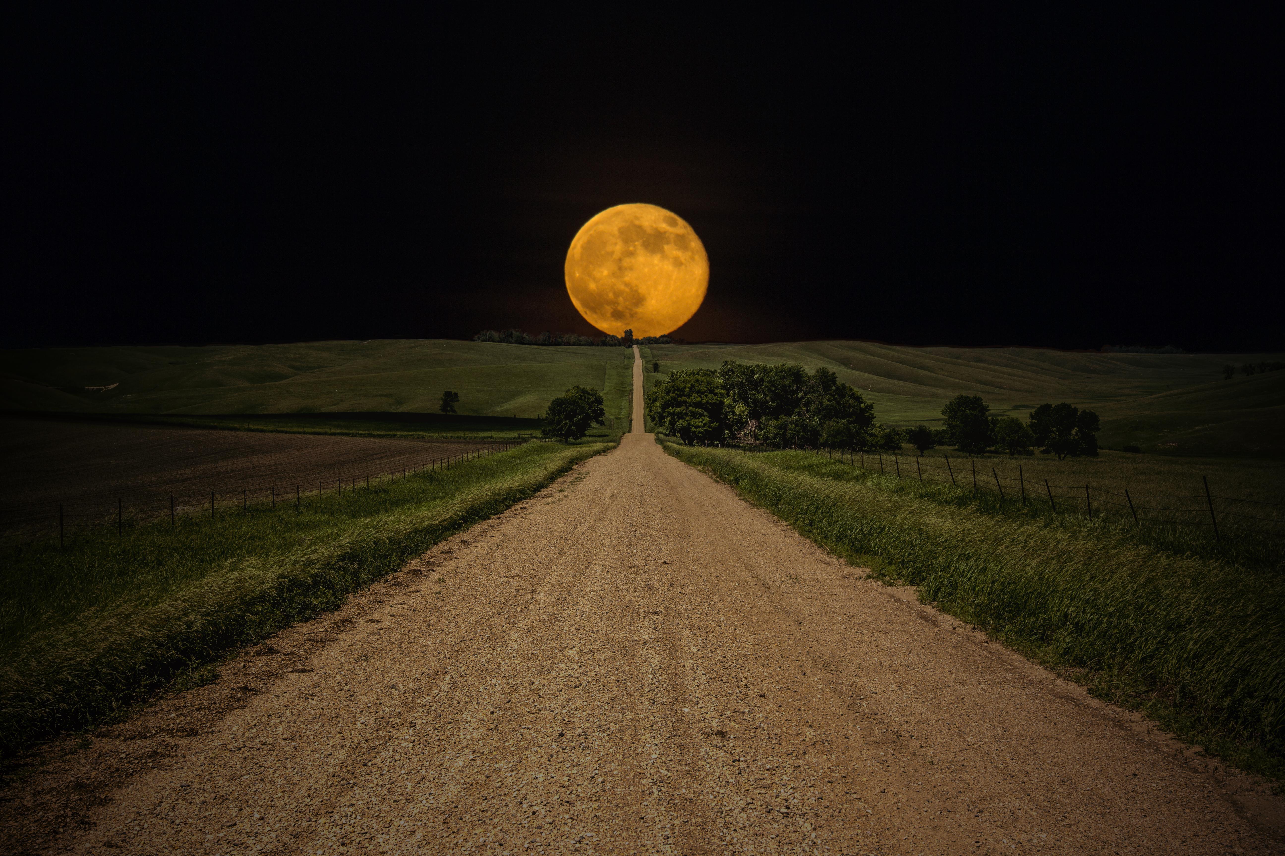 Dirt road leading to a full moon over rolling hills HD Wallpaper