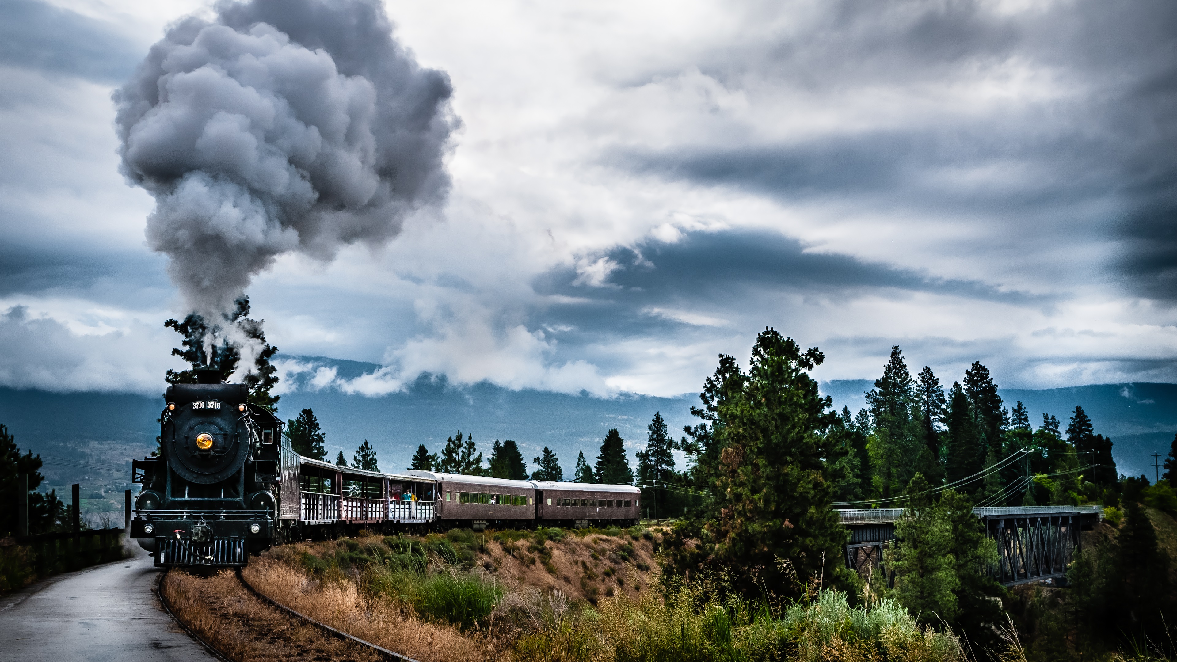 Steam Train on Railroad Tracks with Smoky Clouds HD Wallpaper