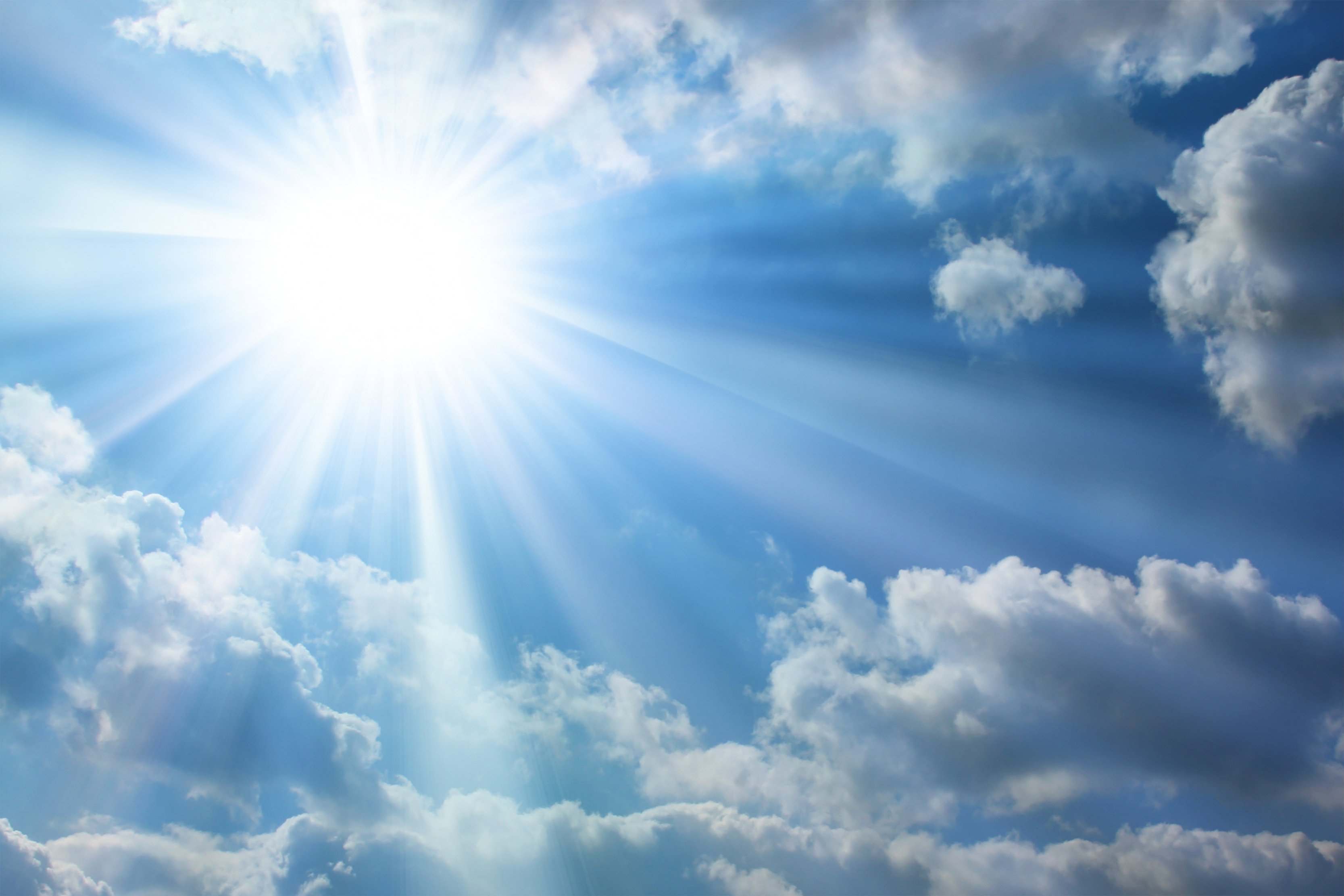 Sun shining through clouds in a blue sky HD Wallpaper