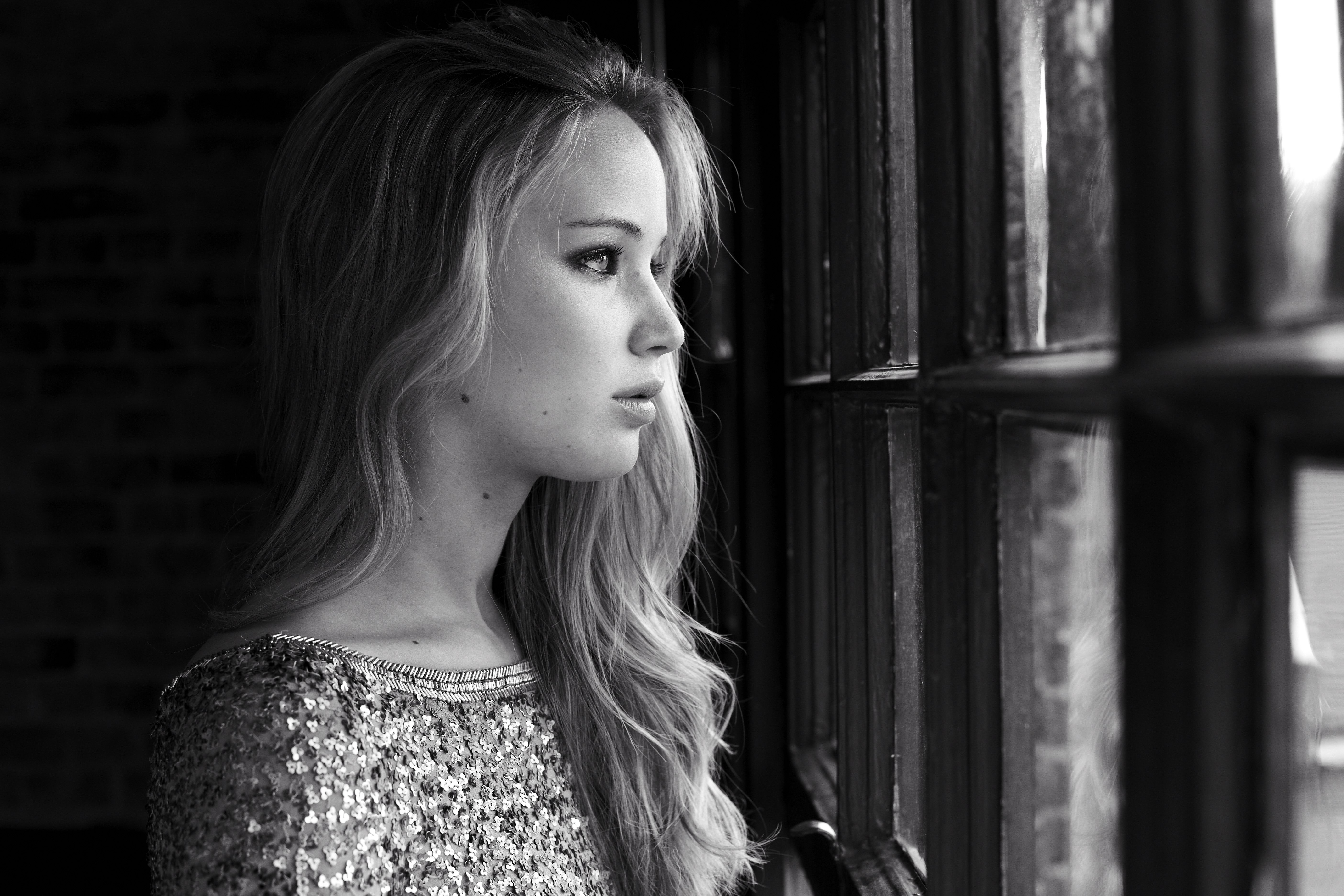 Jennifer Lawrence looking out a window HD Wallpaper