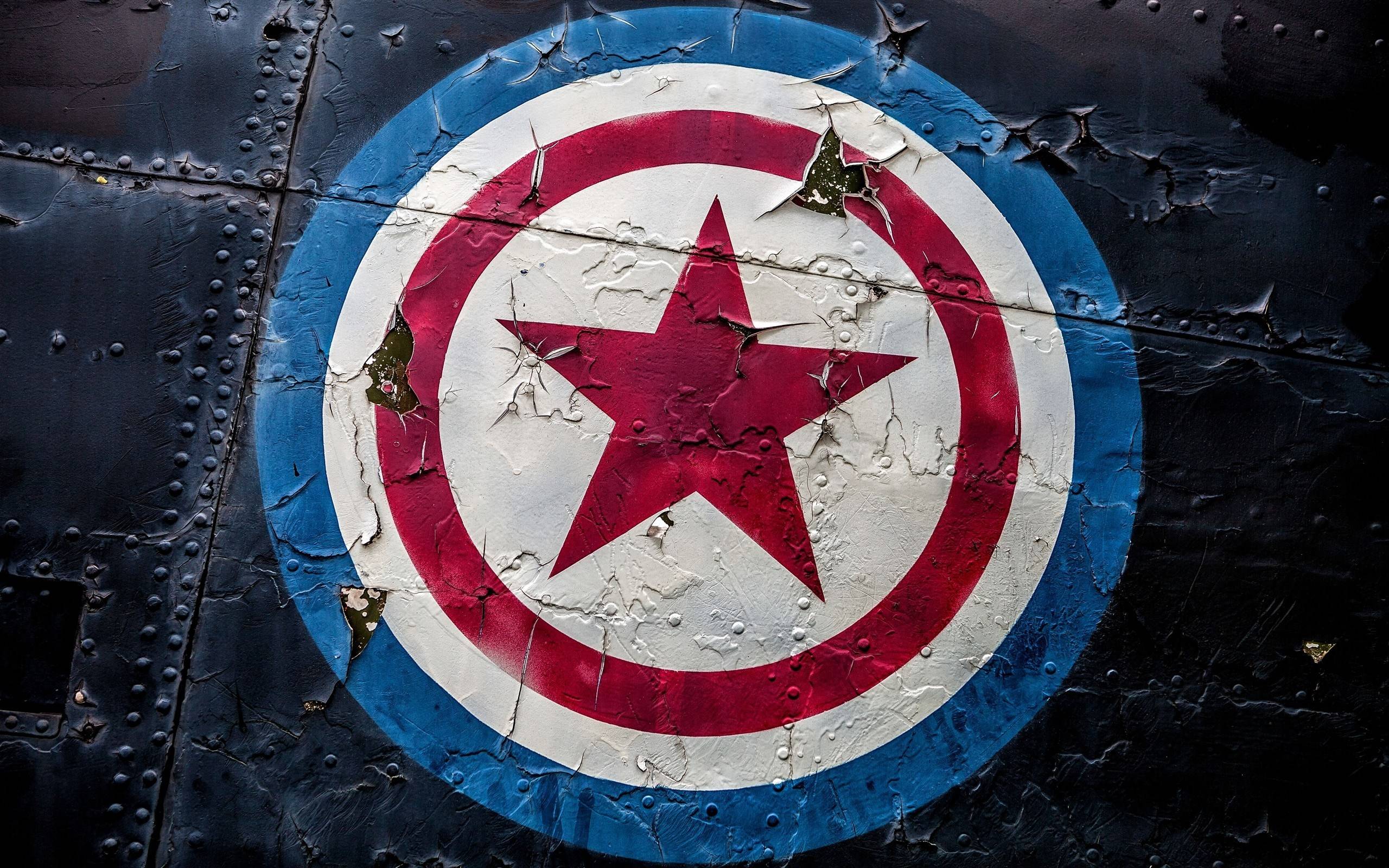 Captain America's Shield Logo on Textured Surface HD Wallpaper