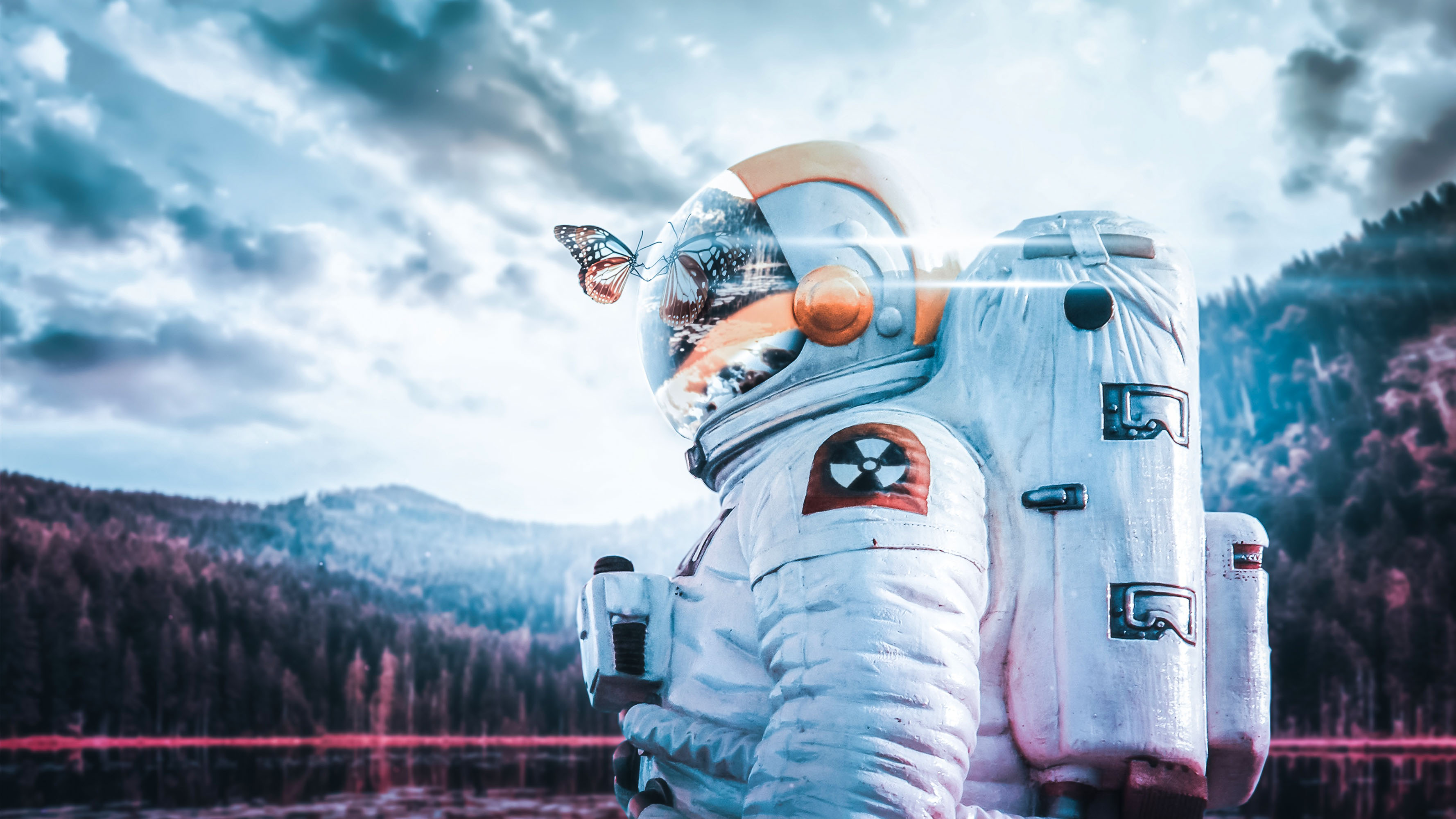 Astronaut with butterfly and radioactive symbol HD Wallpaper