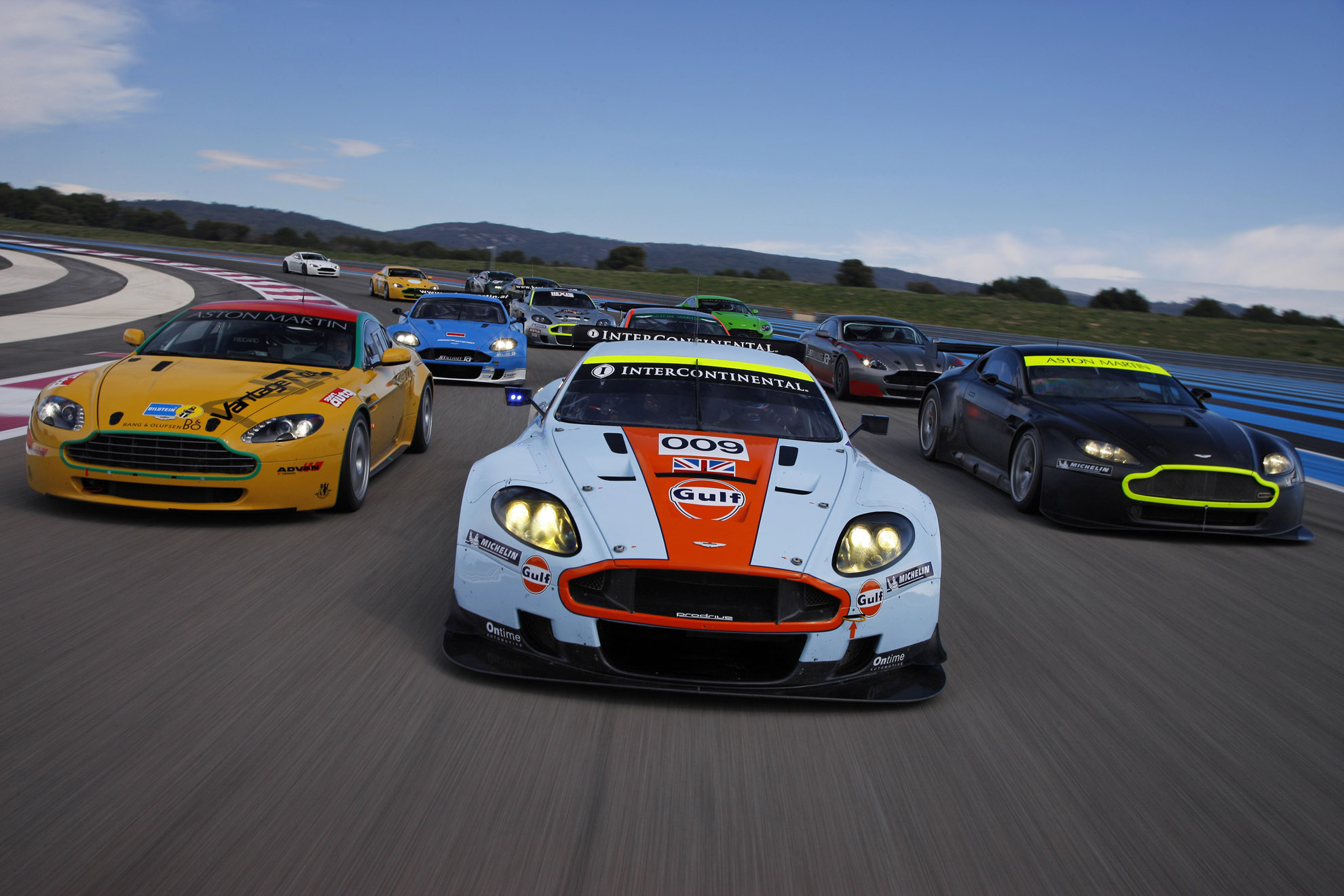 Aston Martin DBR9 race cars on a track HD Wallpaper