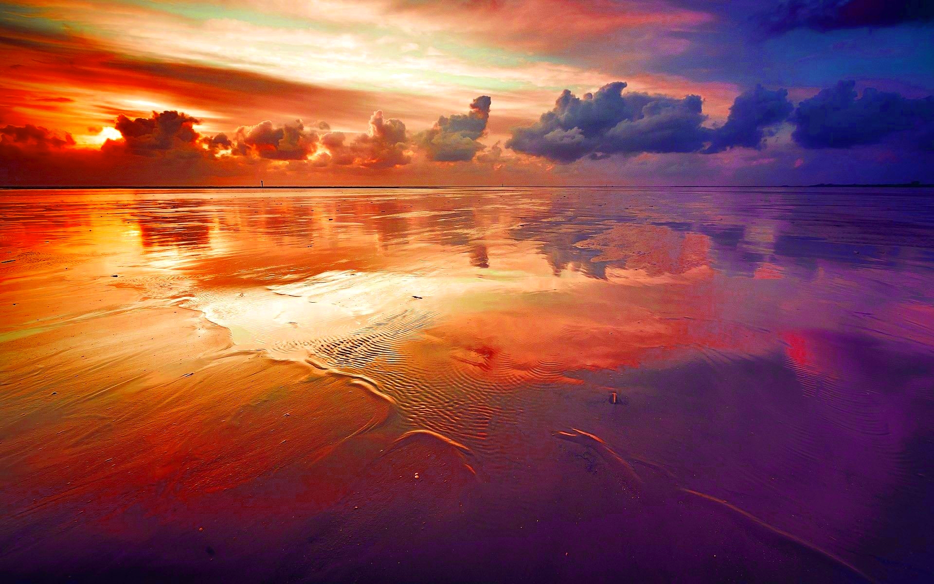 Sunset over a wet sandy beach with colorful clouds HD Wallpaper