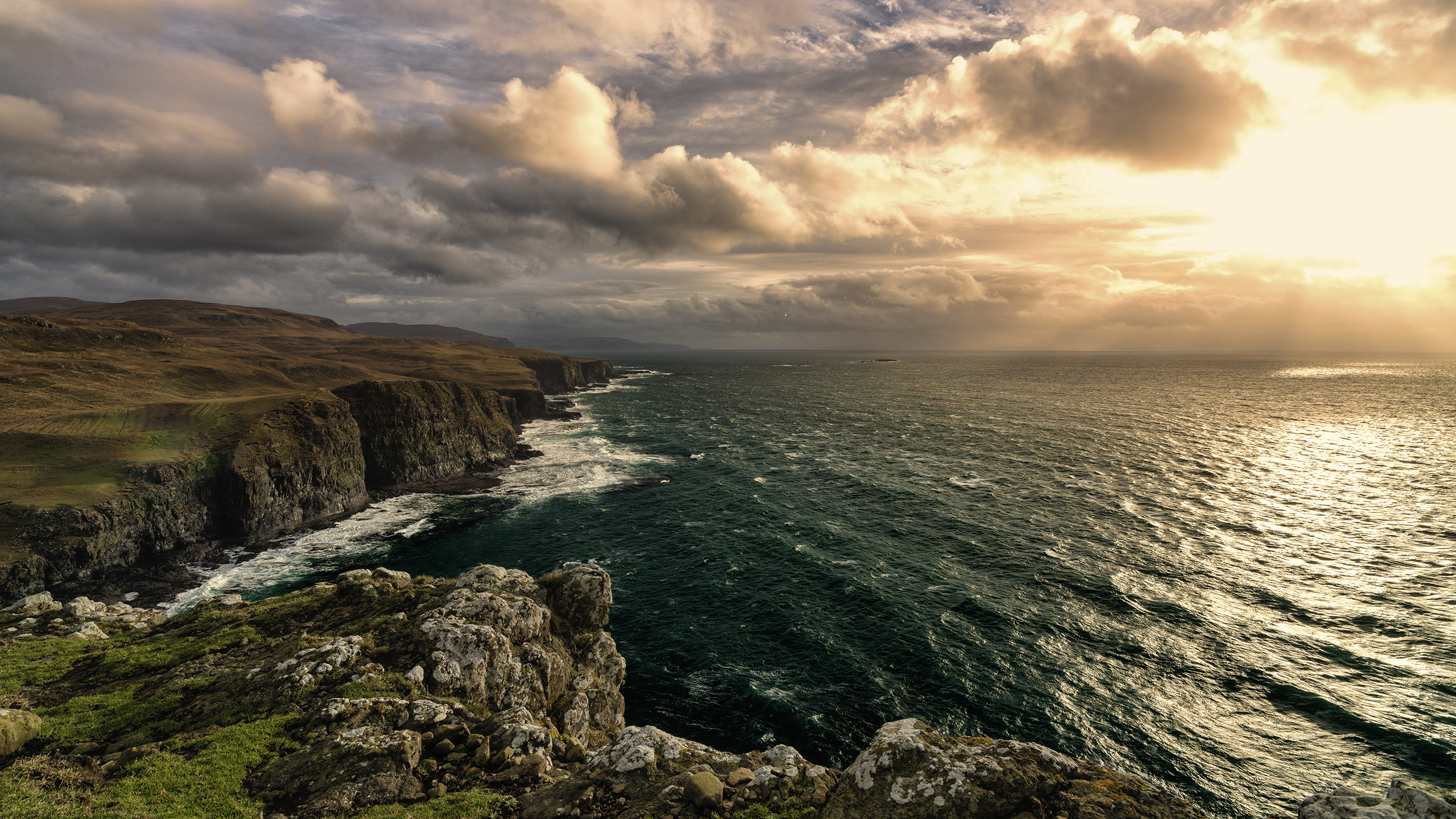 Dramatic coastline with ocean waves under cloudy sky HD Wallpaper