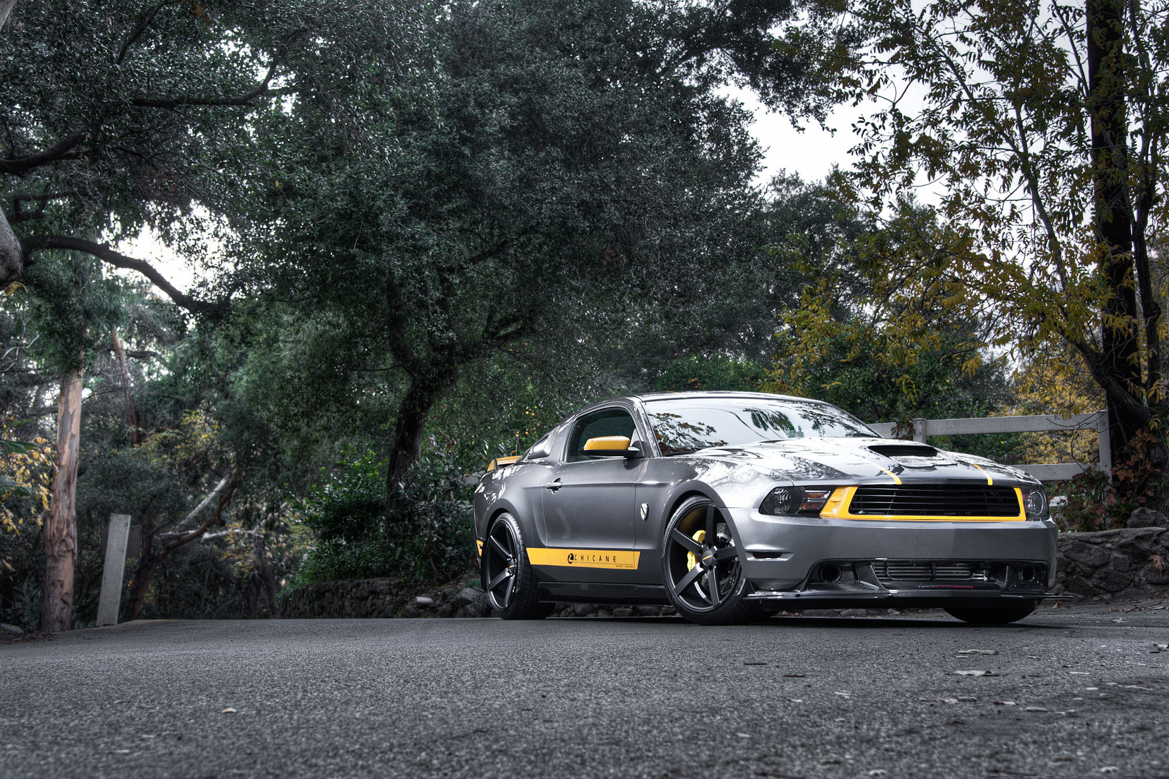 Gray Ford Mustang with yellow accents parked on a road HD Wallpaper