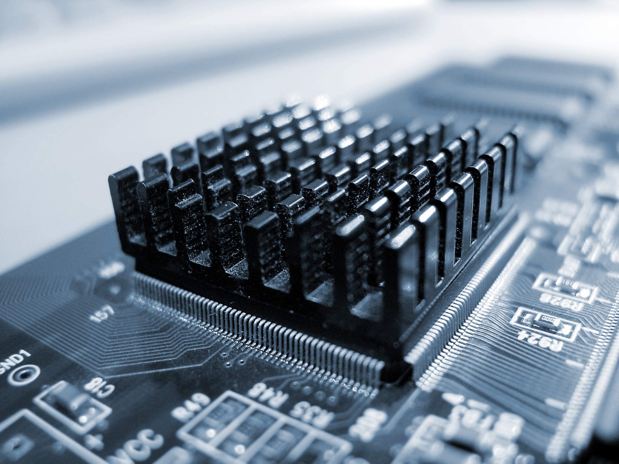Close-up of a computer motherboard with heatsink HD Wallpaper