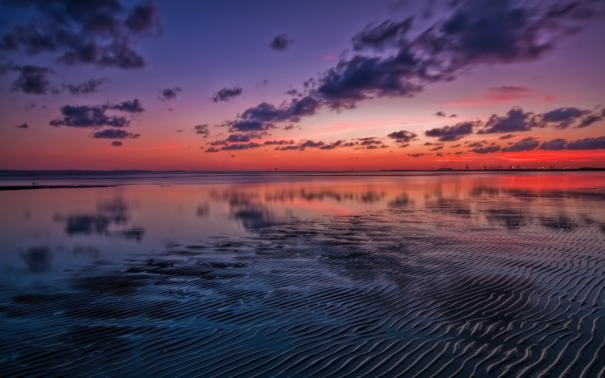 Sunset over the ocean with rippled sand HD Wallpaper