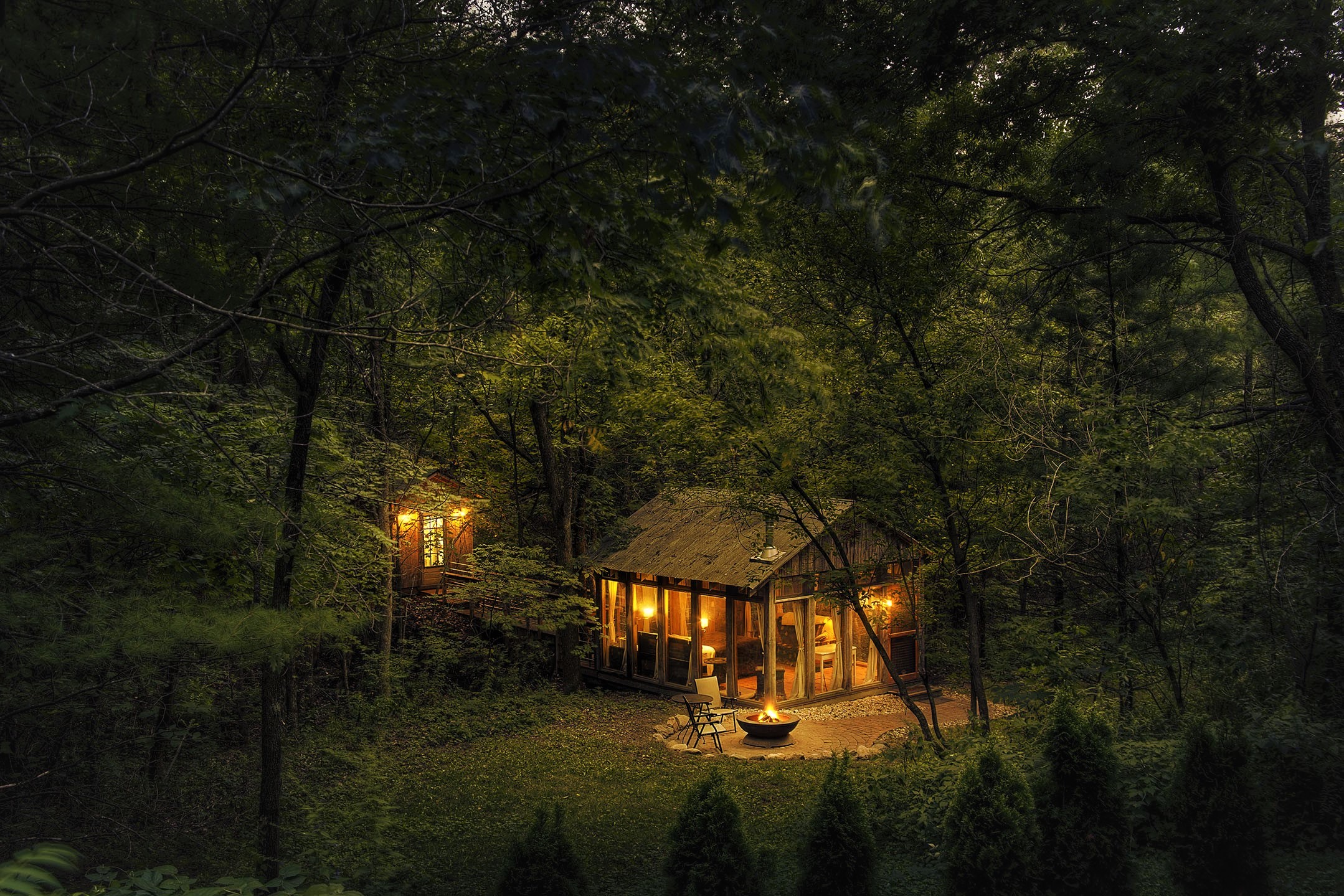 Cozy cabins in a dark forest at night HD Wallpaper