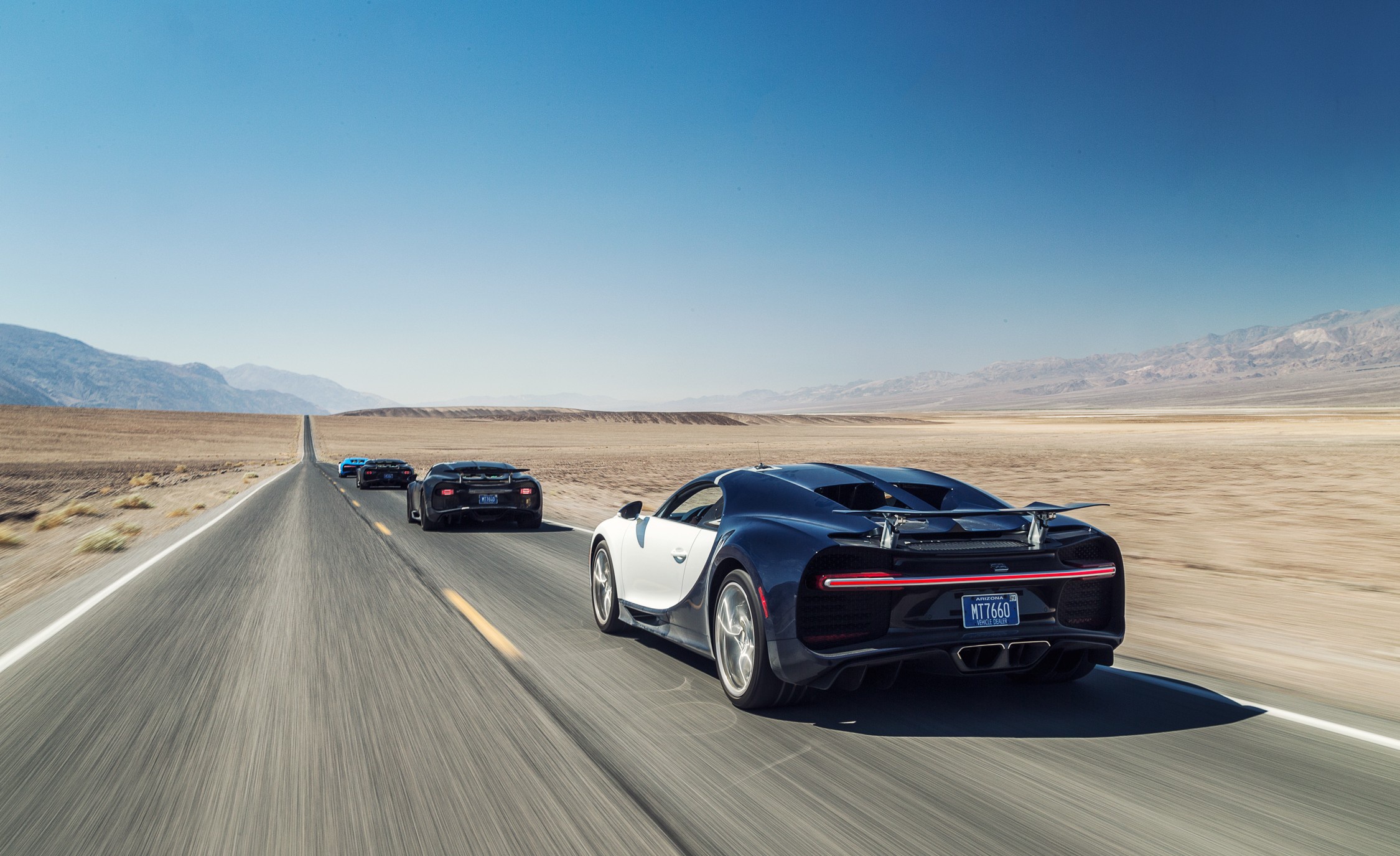 Bugatti Chiron cars driving on a desert road HD Wallpaper