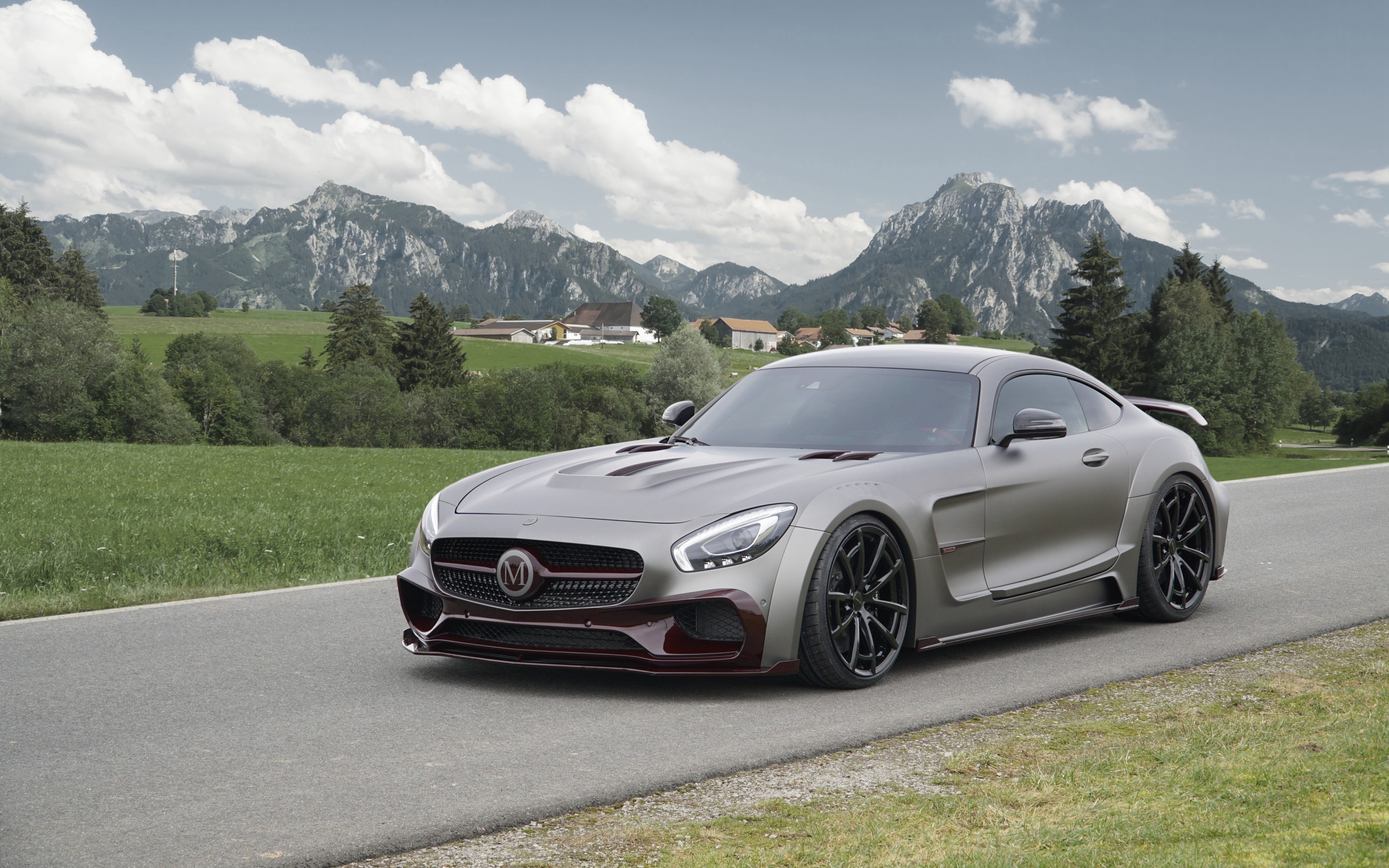 Matte grey Mercedes-AMG GT sports car on a road with mountains HD Wallpaper
