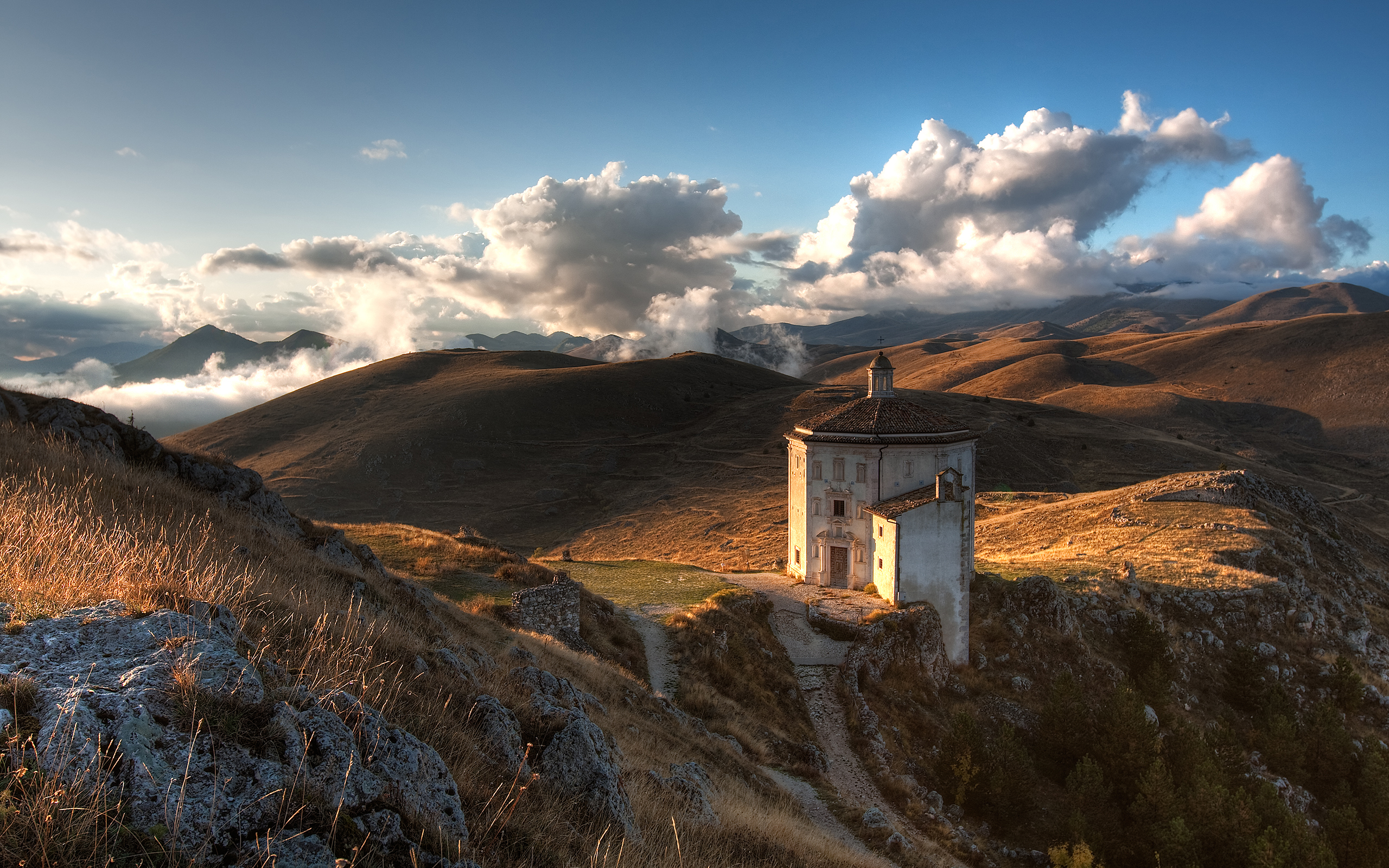 Octagonal church on a grassy hill at sunset HD Wallpaper