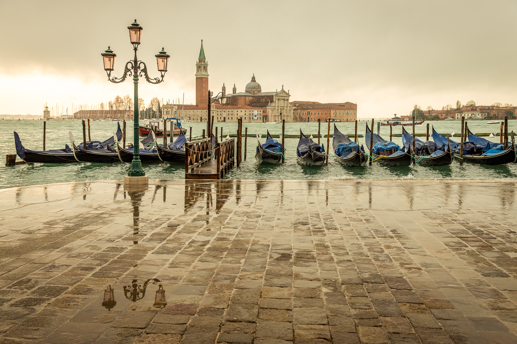 Gondolas docked in Venice with San Giorgio Maggiore church in background HD Wallpaper